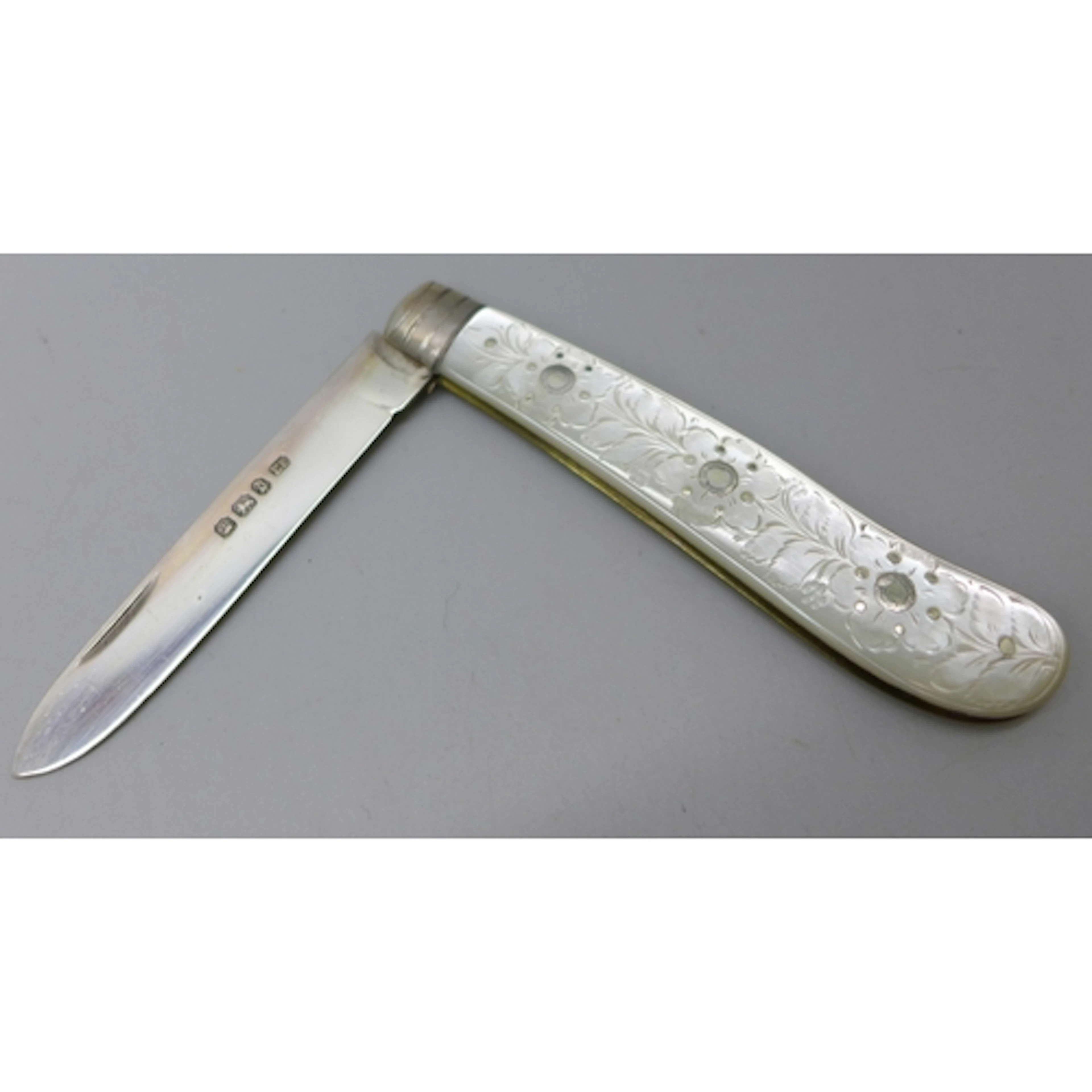 A Victorian carved mother of pearl fruit knife with a silver...