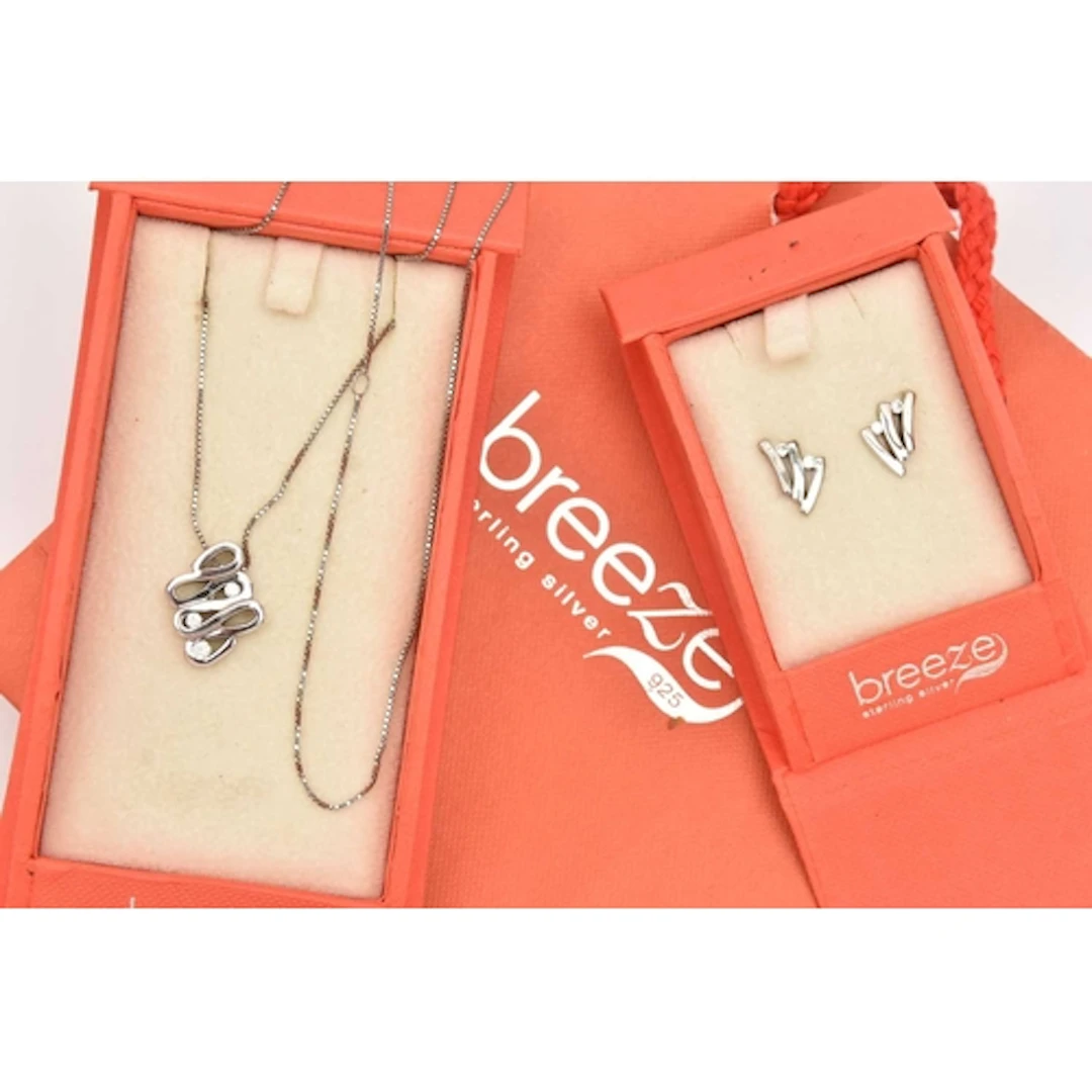 A WHITE METAL NECKLACE AND EARRINGS, a white metal wave styl...