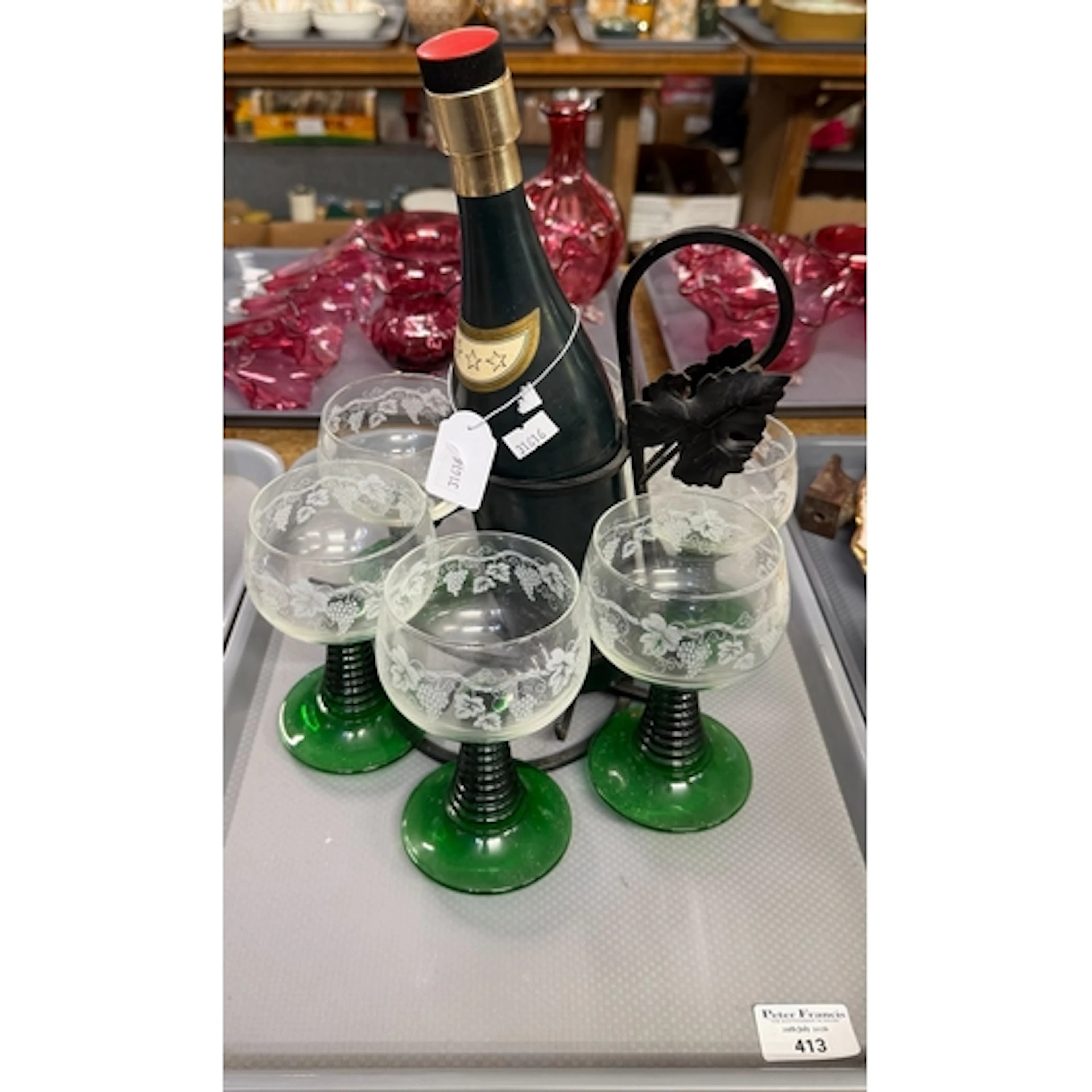 Set of six green stem wine glasses on a musical decanter wit...