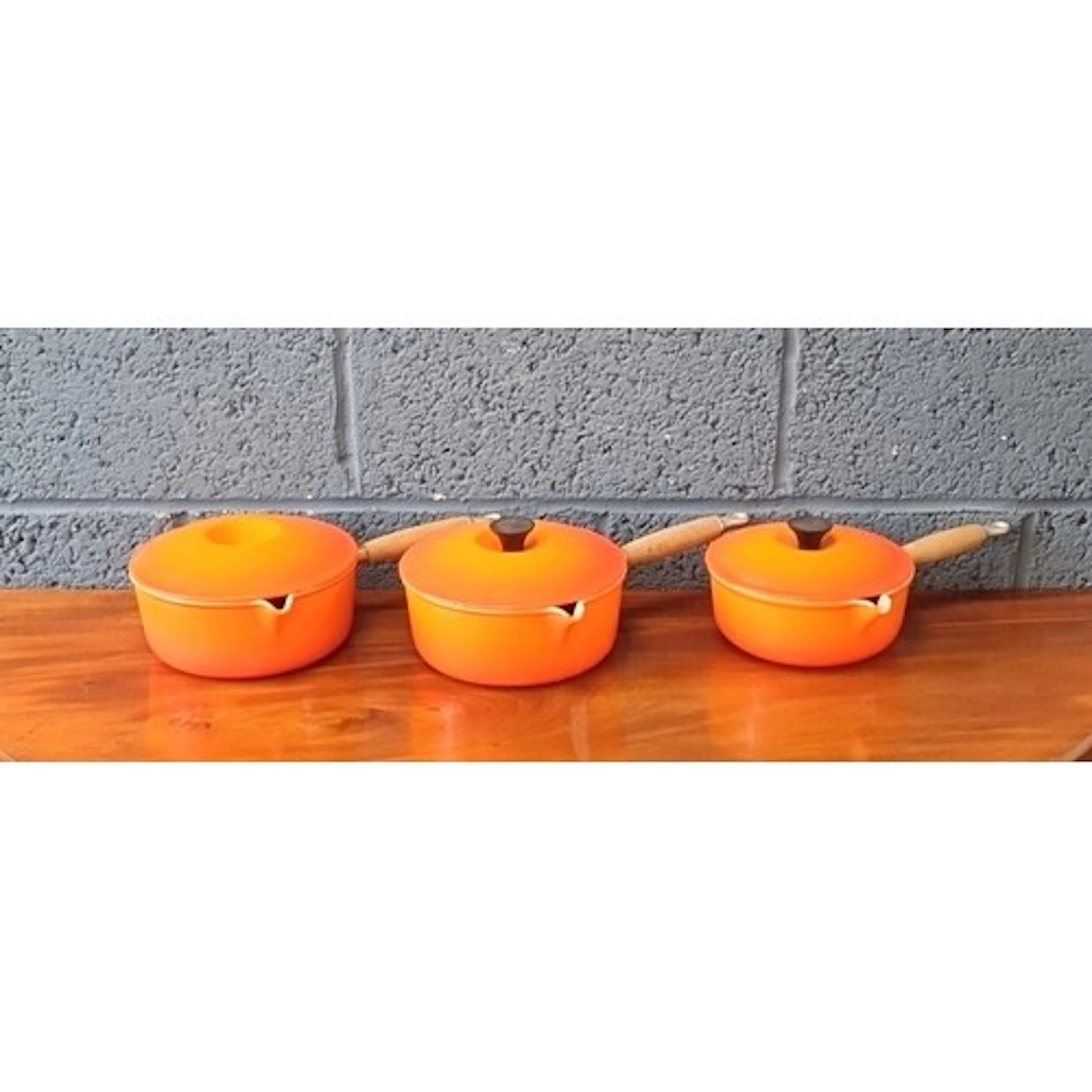Le Creuset enamelled cast-iron lidded saucepans, orange