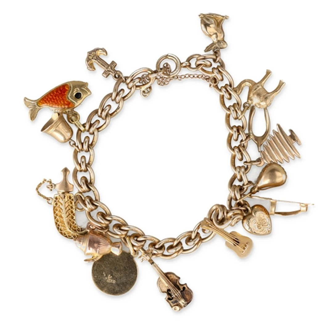 A 9CT GOLD CHARM BRACELET With various charms including many...