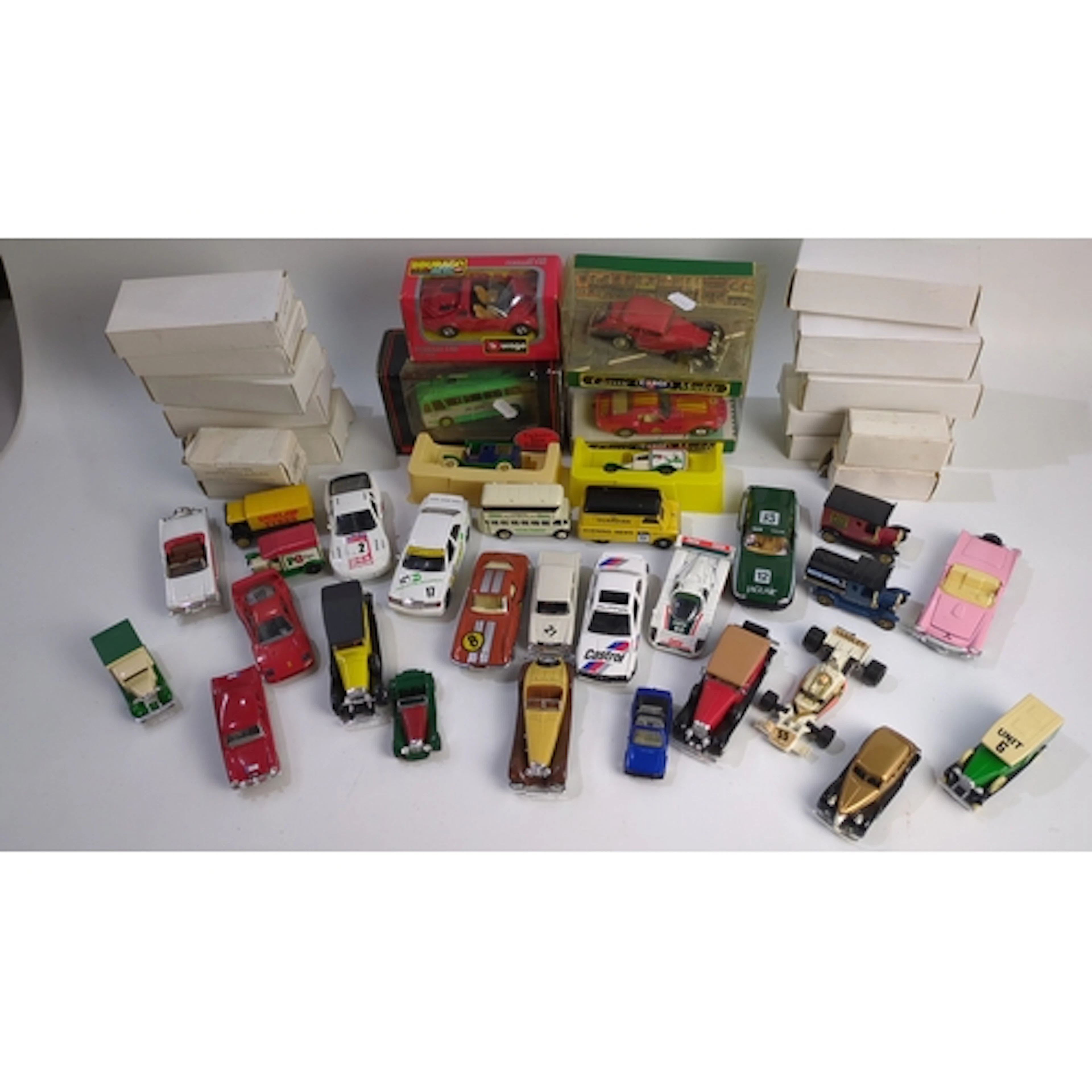 A collection of die-cast model vehicles, including boxed Bur...