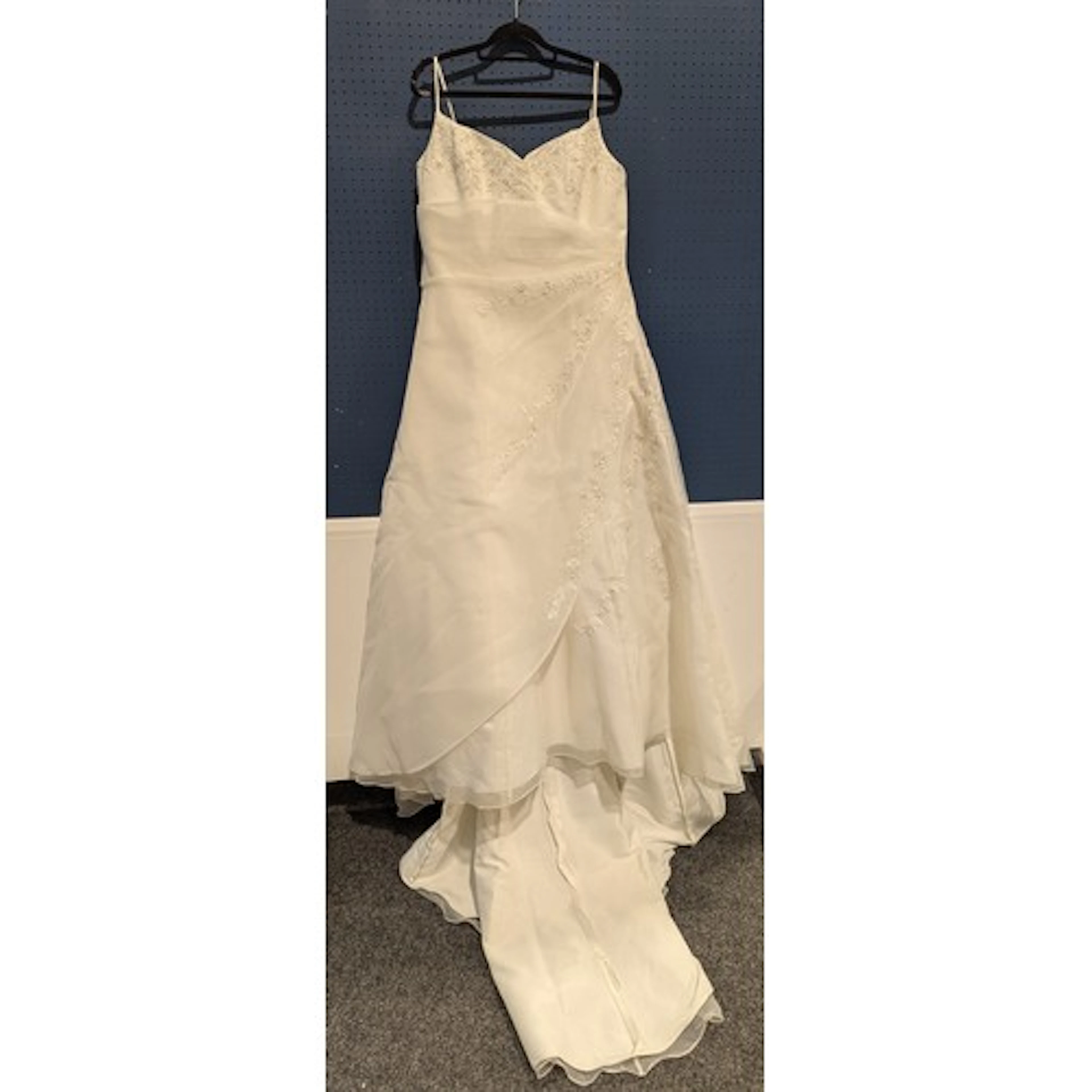 A wedding dress by Romantica, size 18, unused