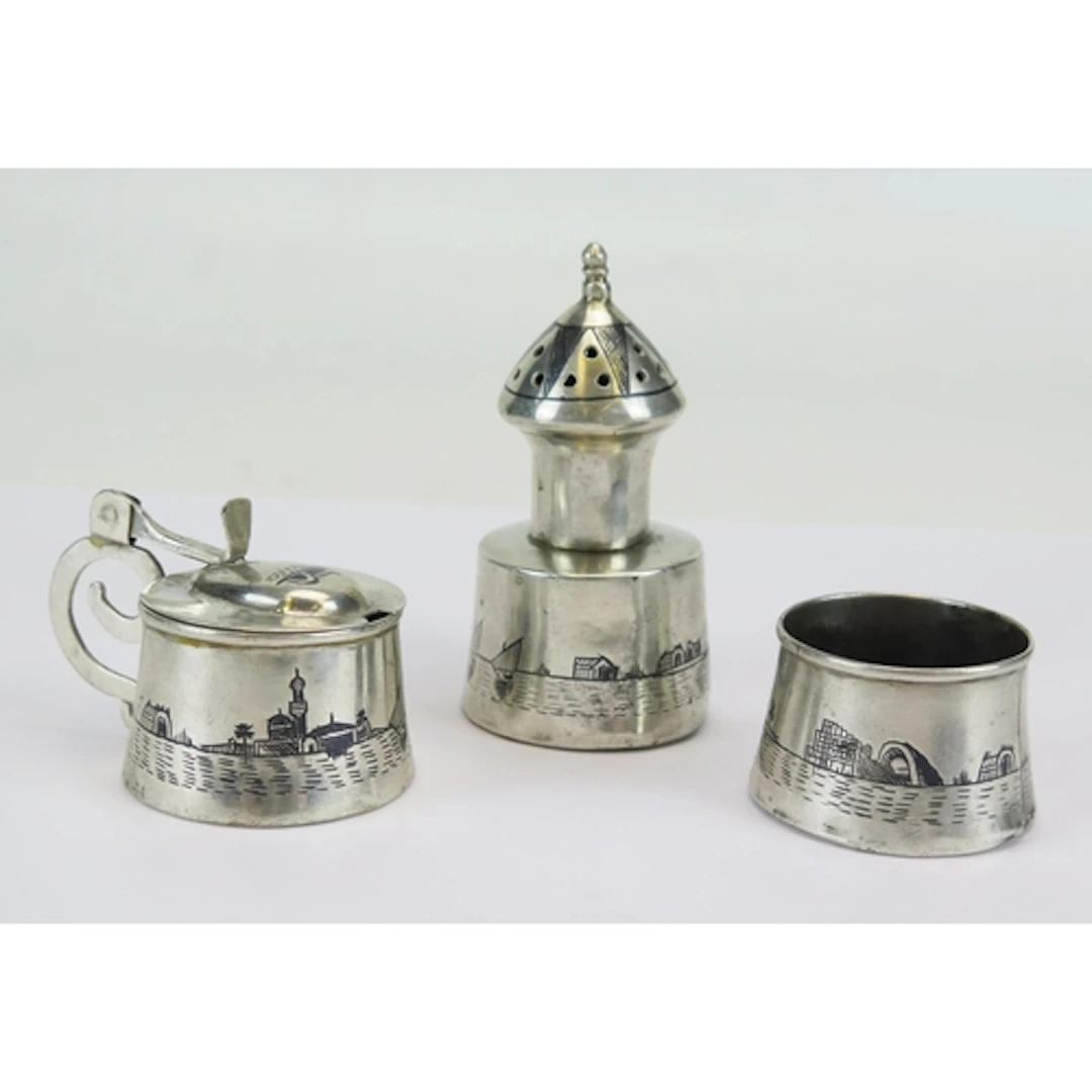 An Egyptian silver three-piece condiment set, with niello de...