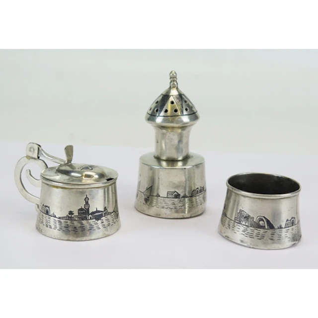An Egyptian silver three-piece condiment set, with niello de...