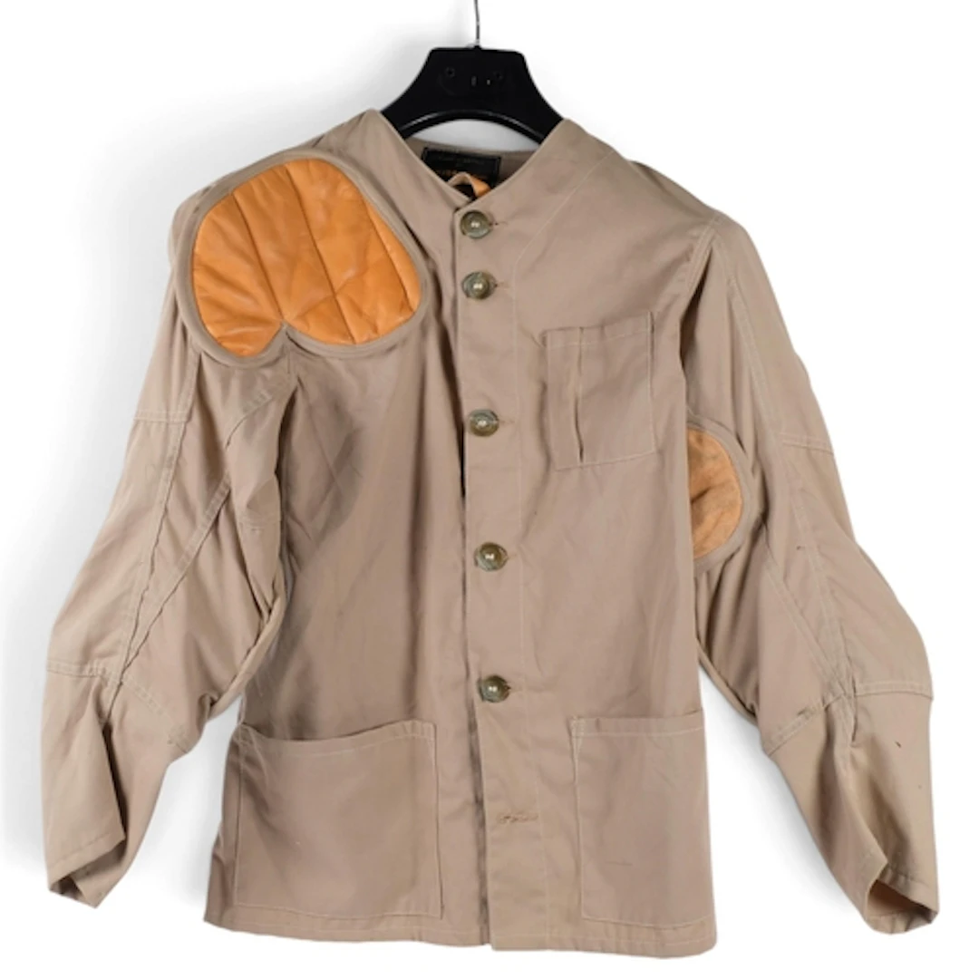 A Buttstop shooting jacket with padded leather shoulders and...