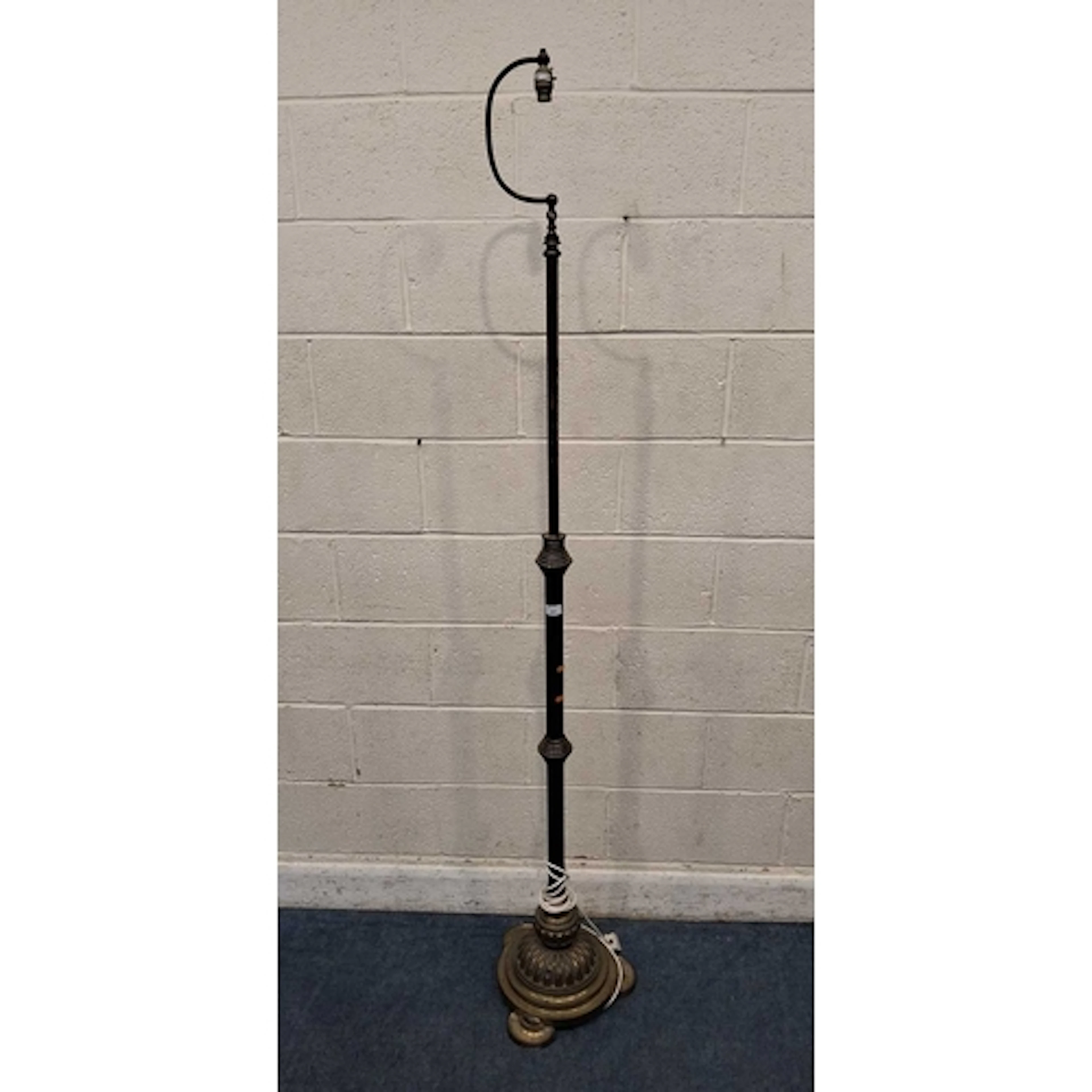 A BRASS TELESCOPIC STANDARD LAMP, with a curved arm at the t...