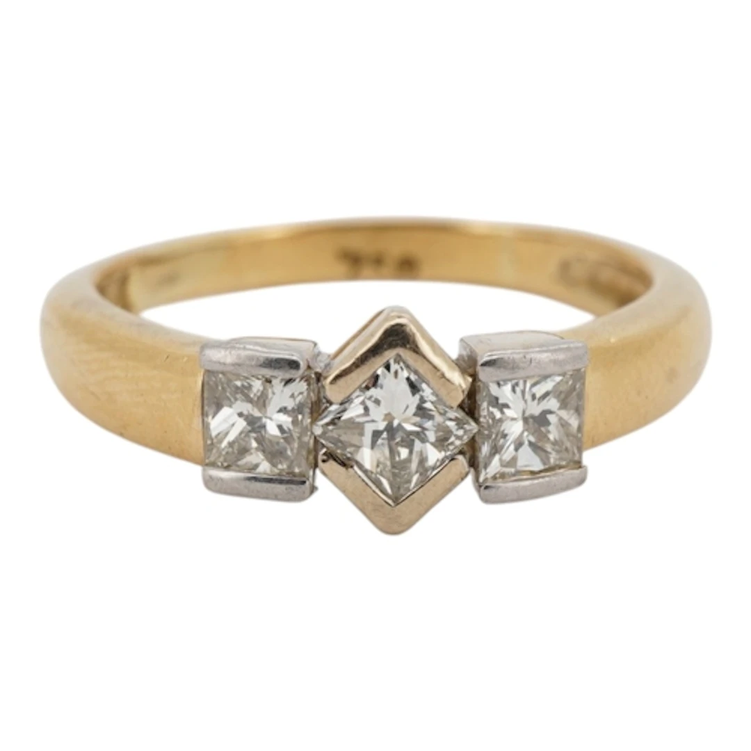 A diamond ring, collet-set with three princess-cut diamonds ...