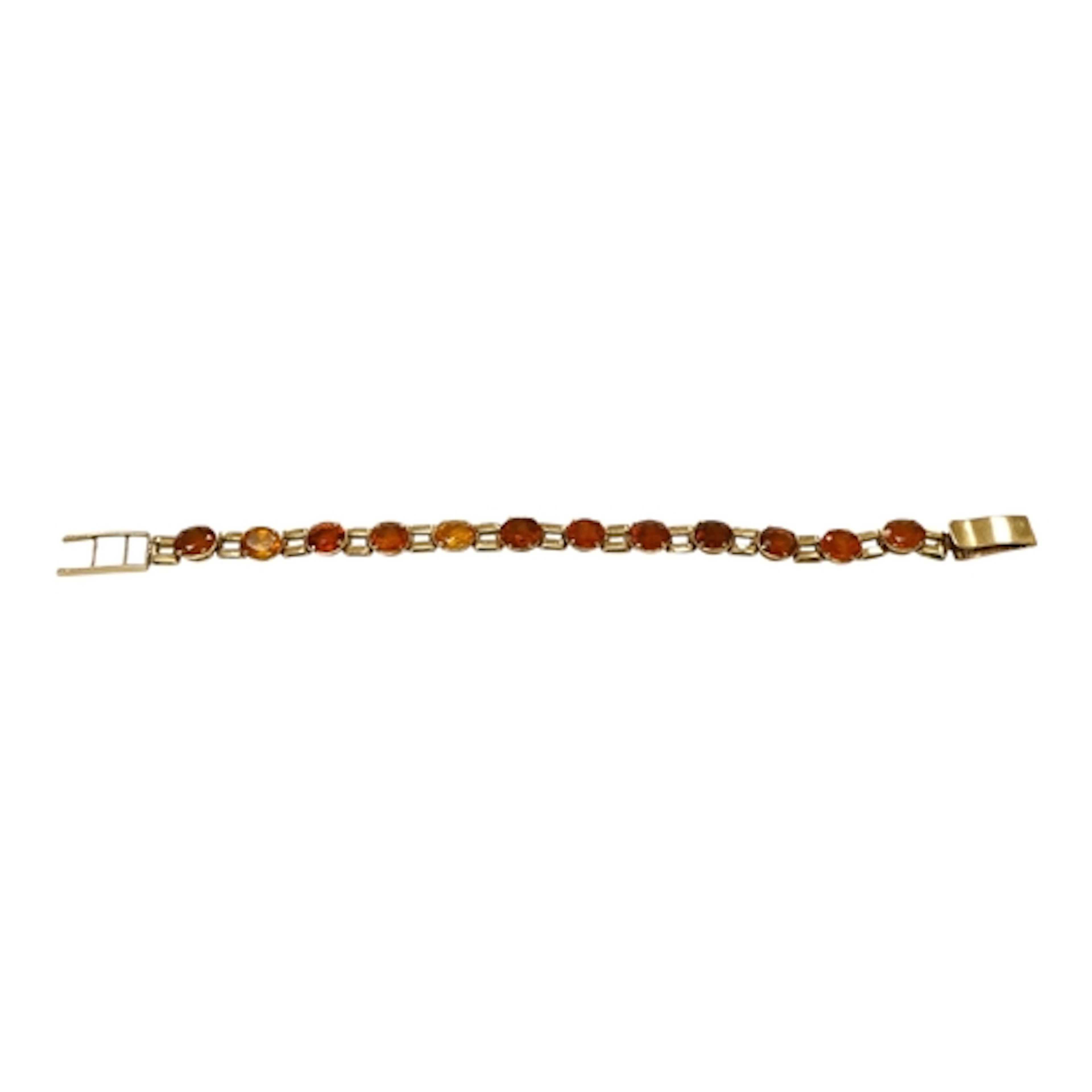 An unmarked yellow metal and twelve stone oval cut citrine s...