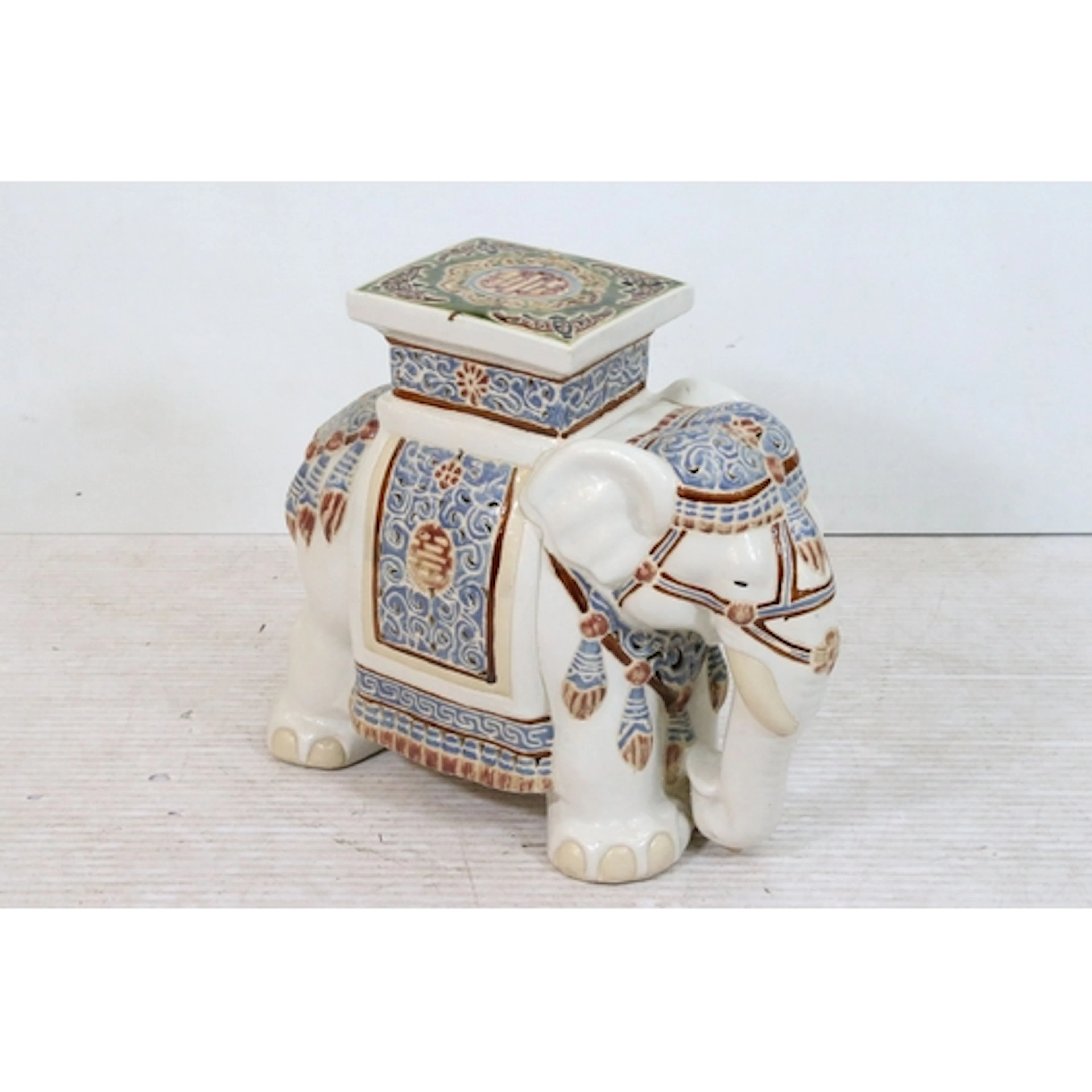 20th century ceramic elephant garden seat, having zhou chara...
