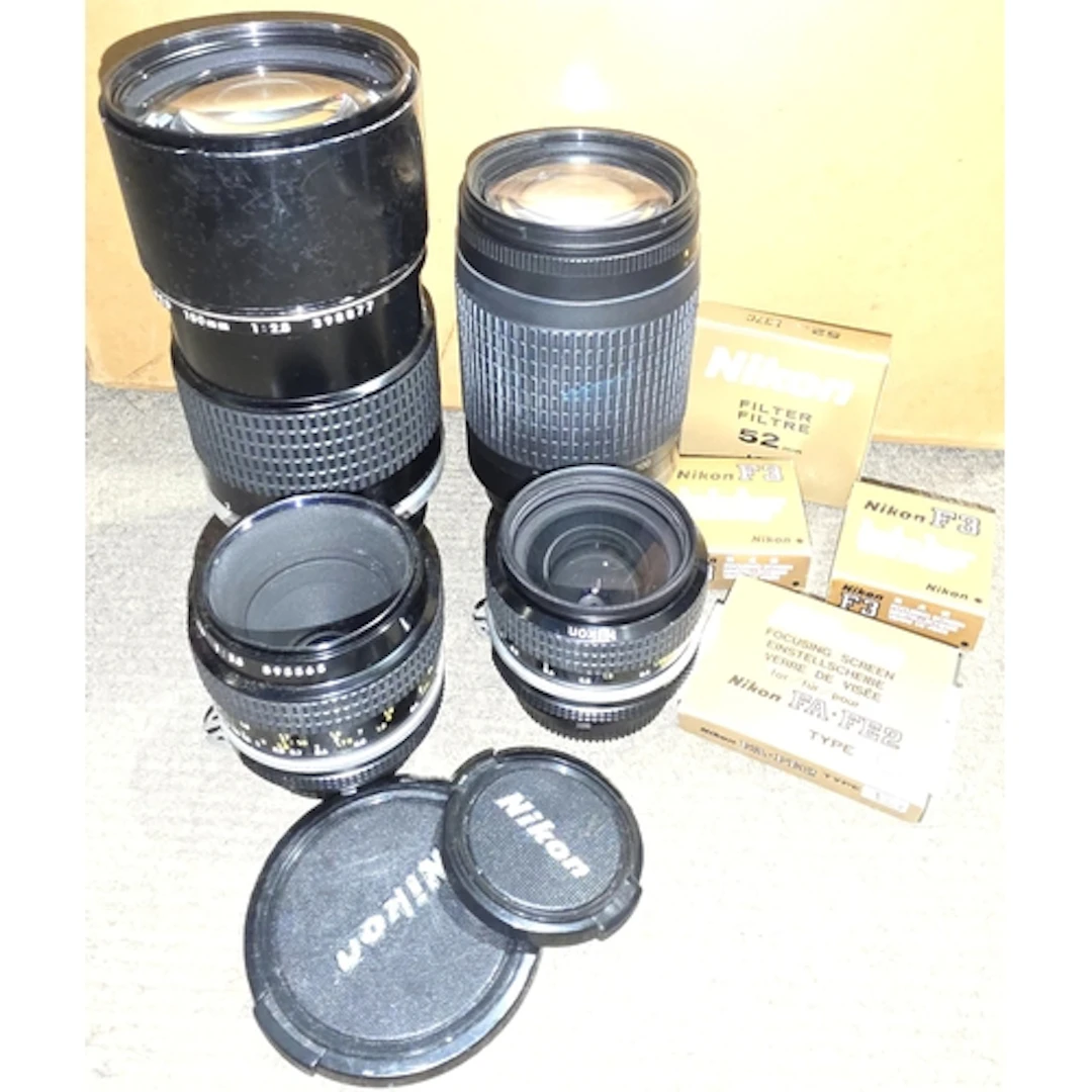 Four Nikon Nikkor lenses AF 70-300mm, 1:4-5.6G, 180mm 1:28, ...