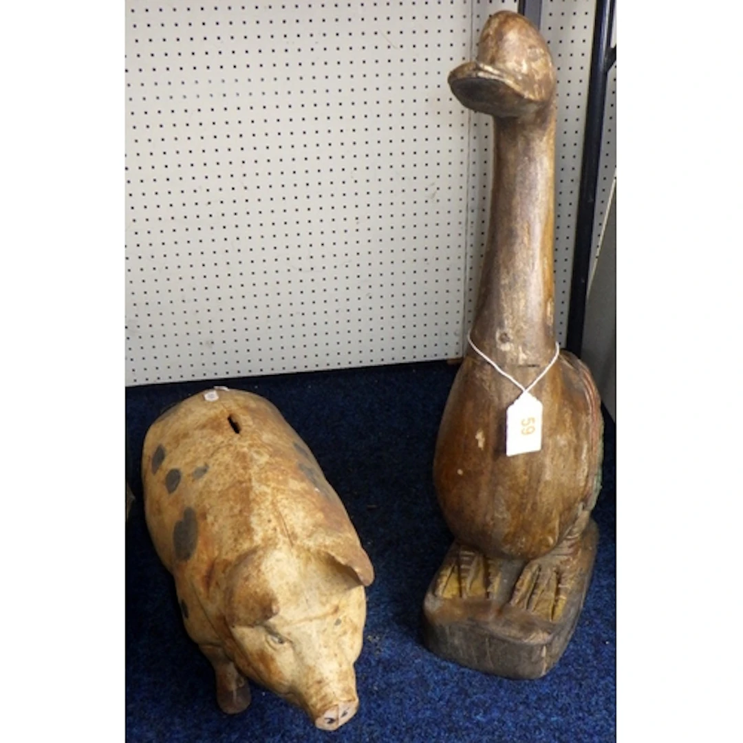 A large cast money pig together with a carved duck (2)