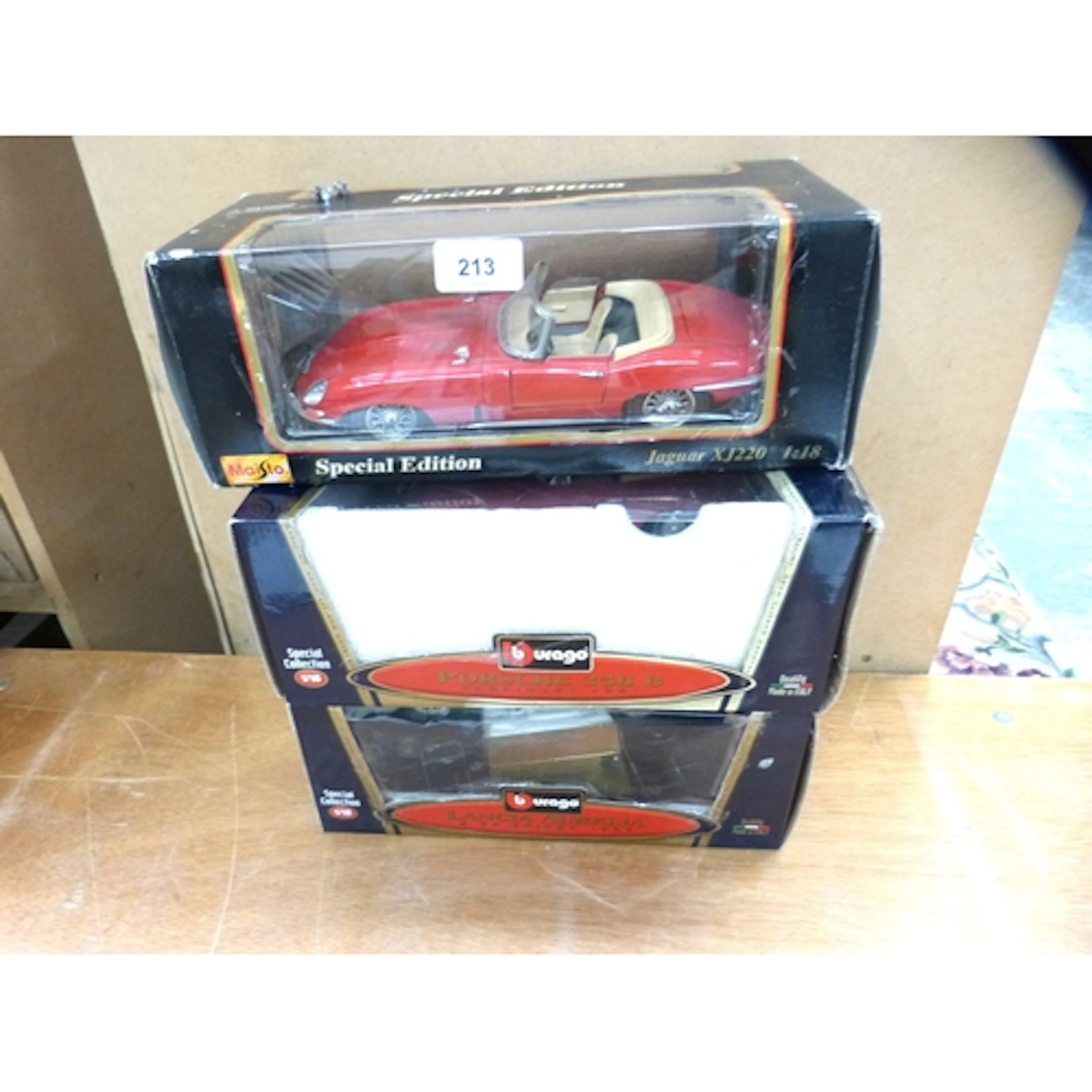 Three Burago 1:18 scale diecast to include Lancia, Porsche, ...