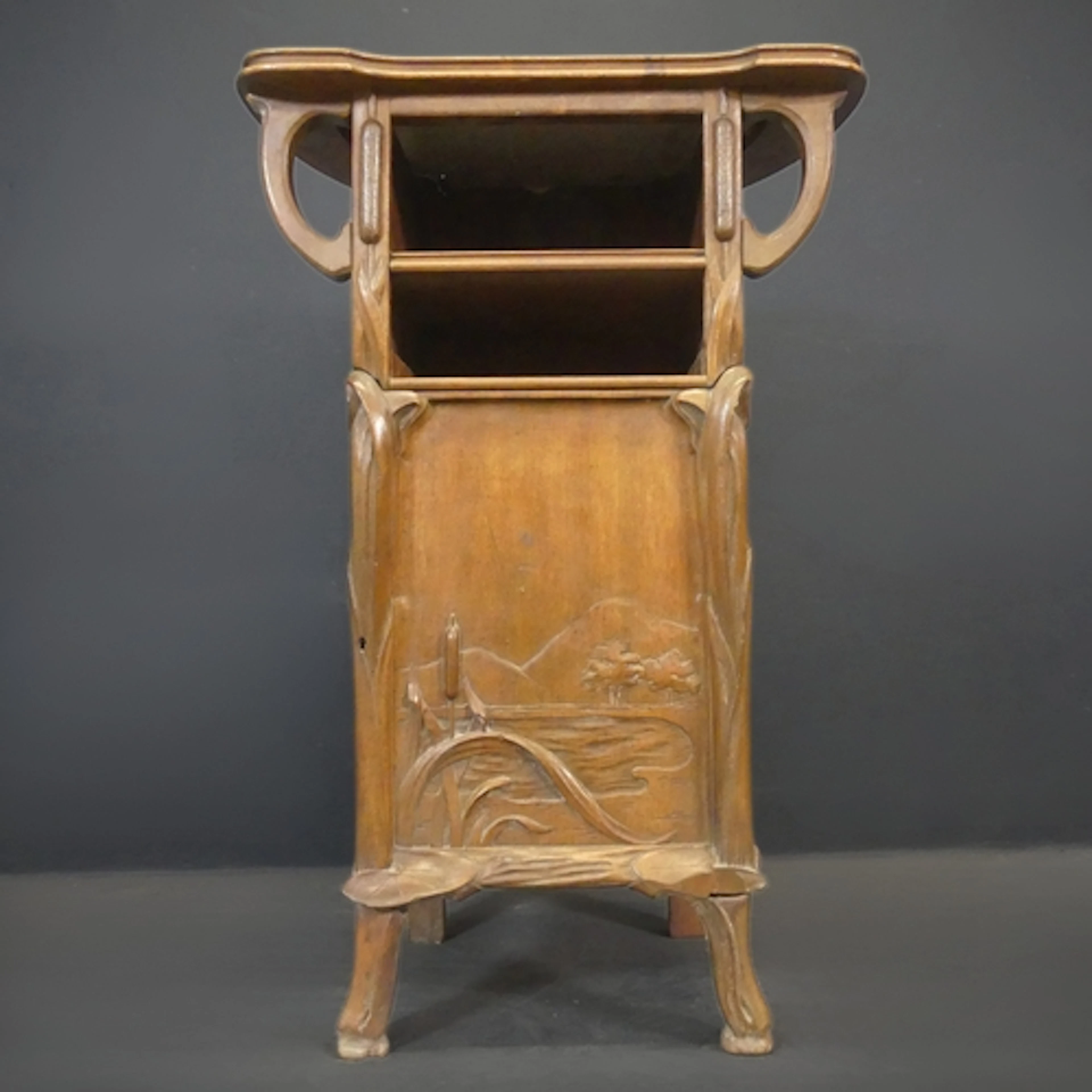 An Art Nouveau carved mahogany and marble lined cabinet in t...