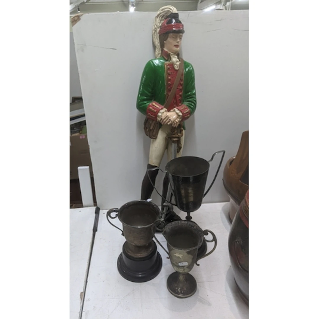 A resin cast figure of a soldier, along with three twin hand...
