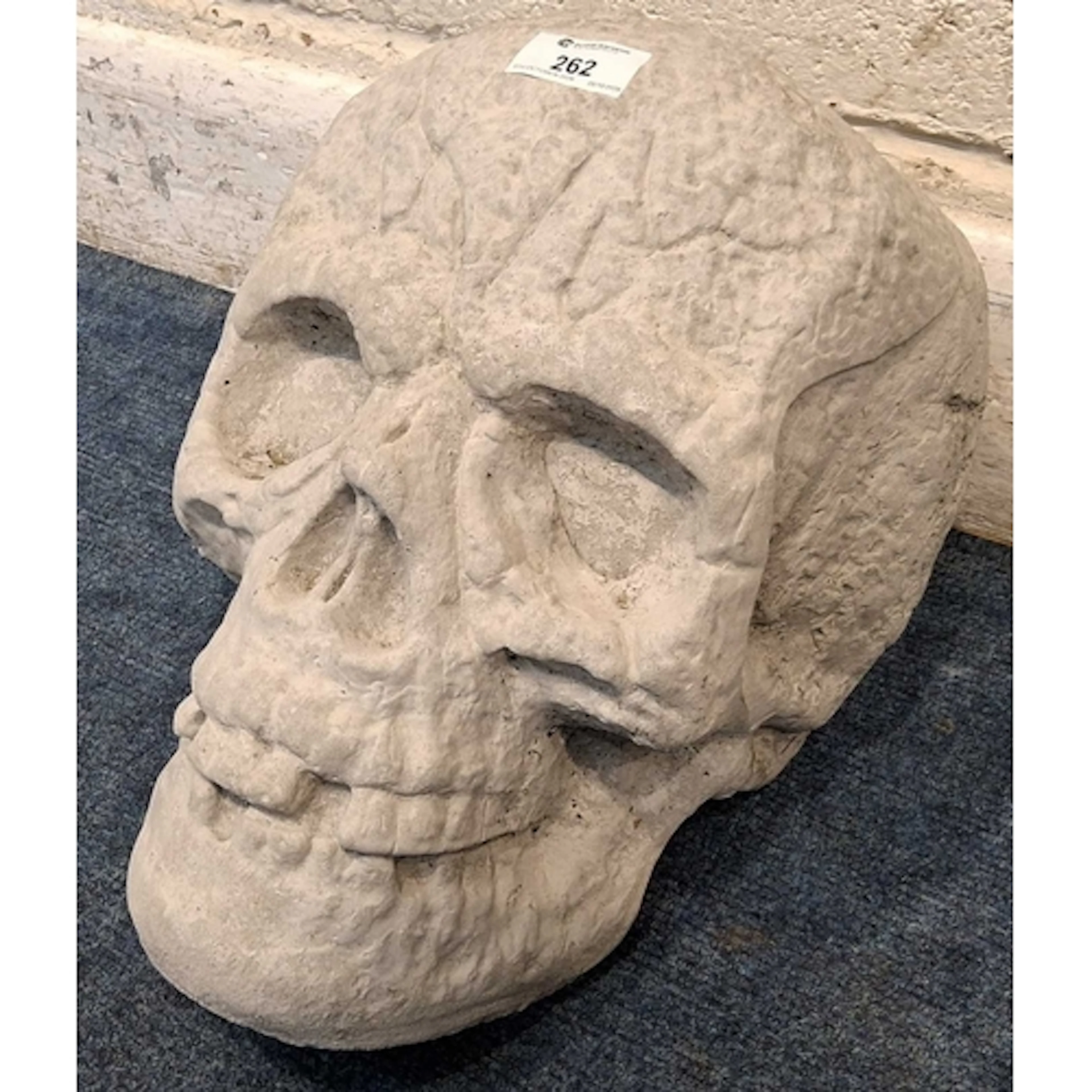 A CONCRETE SKULL (approximate height 26cm) overall good co...