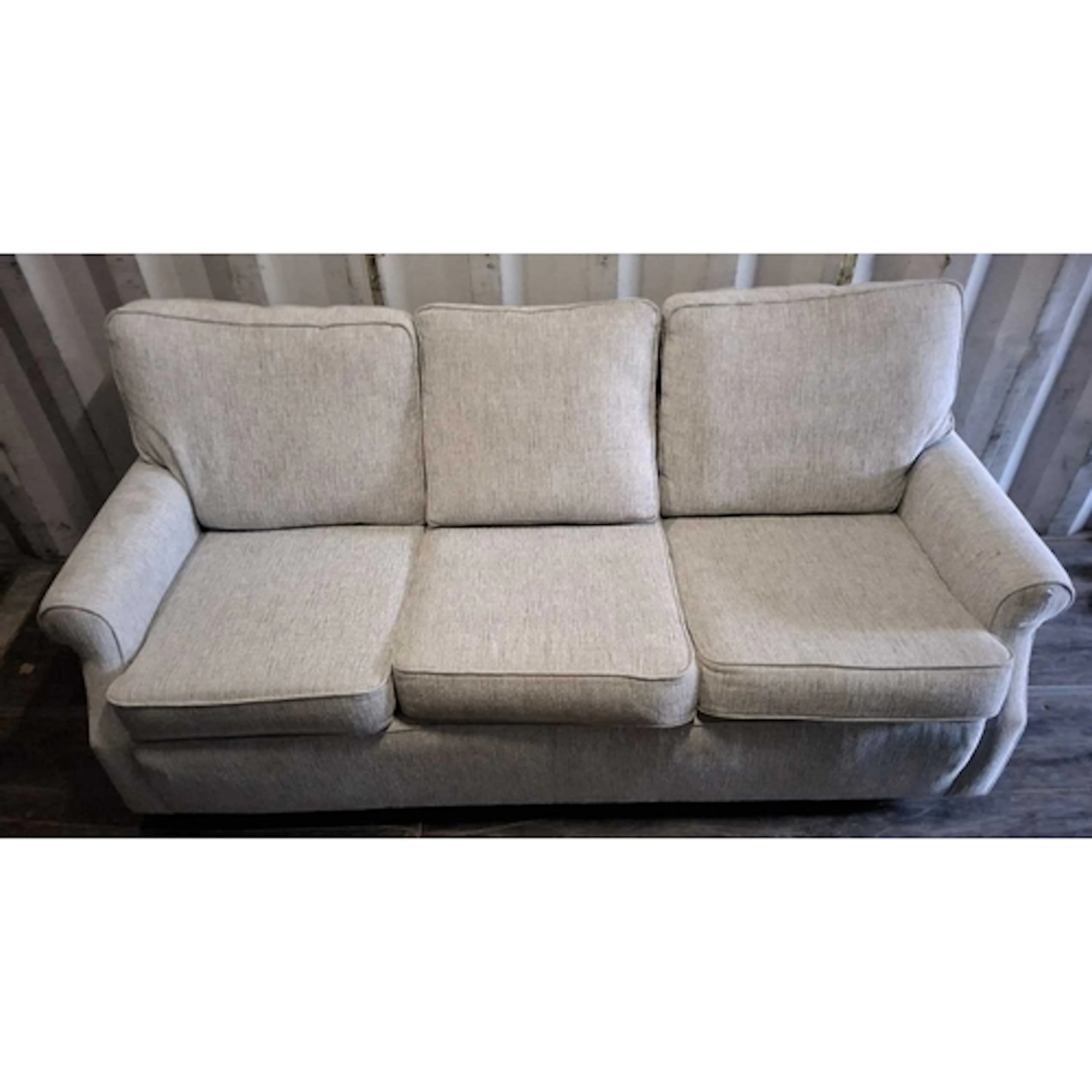 A MODERN GREY UPHOLSTERED THREE-SEATER SOFA, raised on casto...
