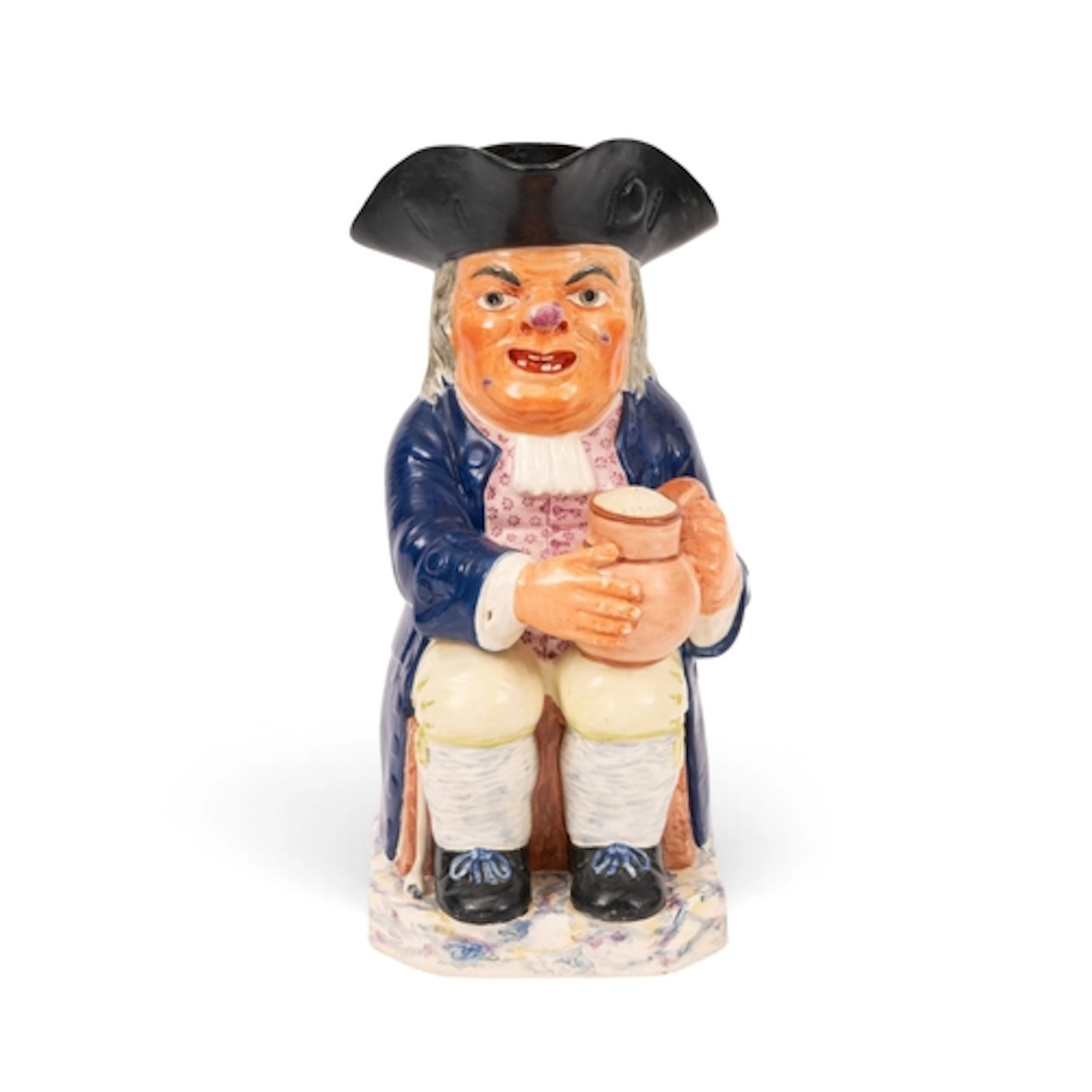 A creamware Toby jug, c.1800-20, of Ordinary type, modelled ...