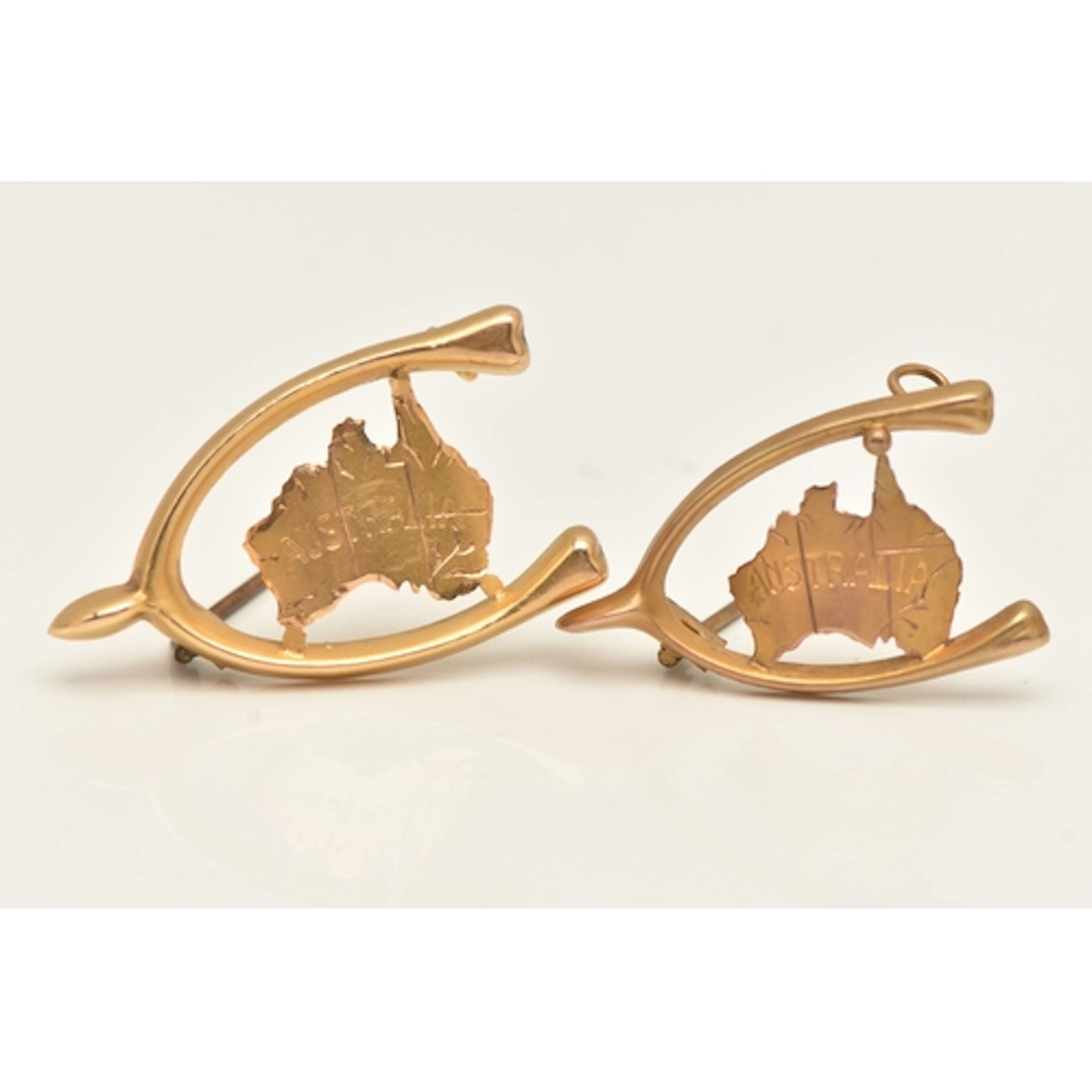 TWO YELLOW METAL 'AUSTRALIA' WISHBONE MAP BROOCHES, both ins...