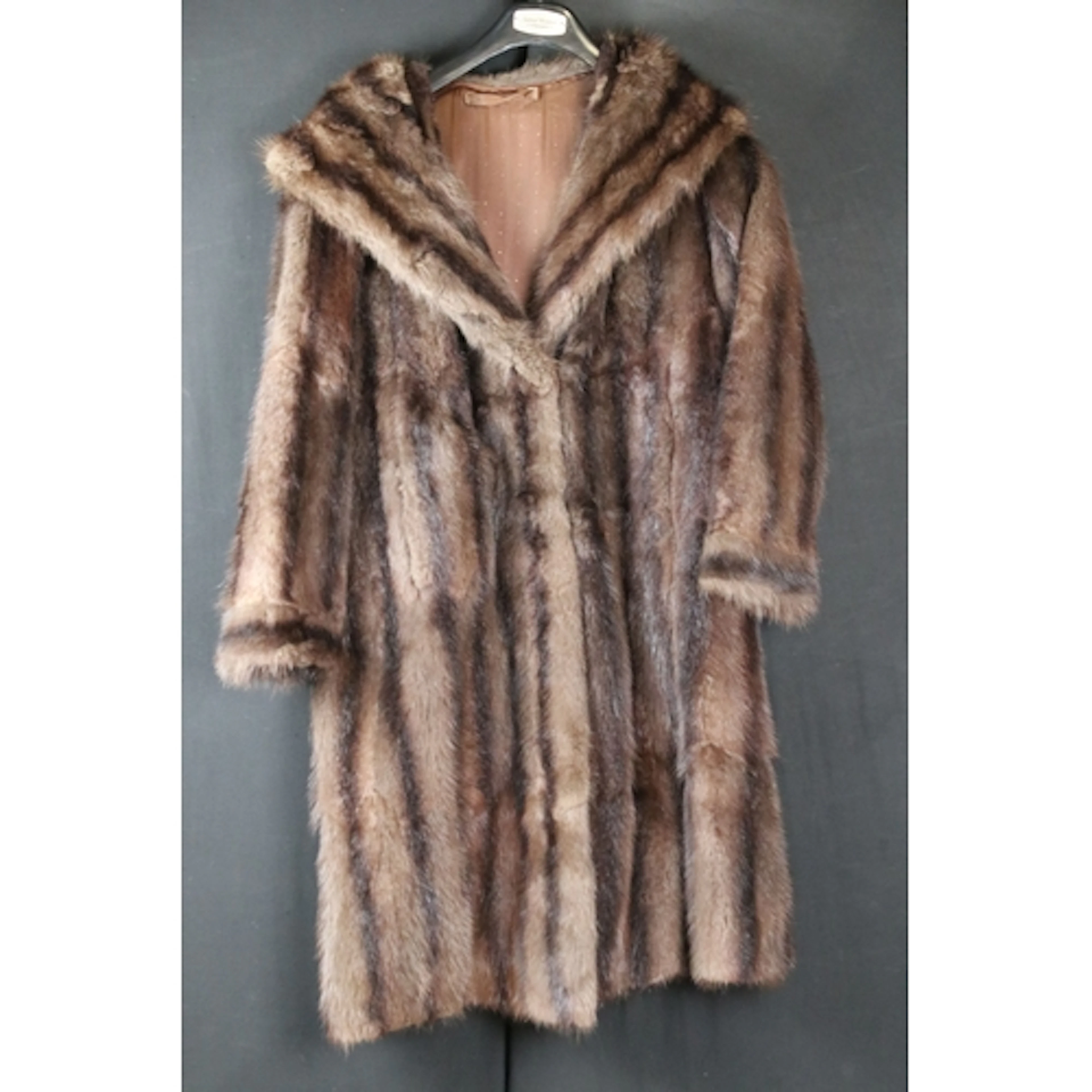 Dark brown fur coat having inner hook and loop fastenings, l...