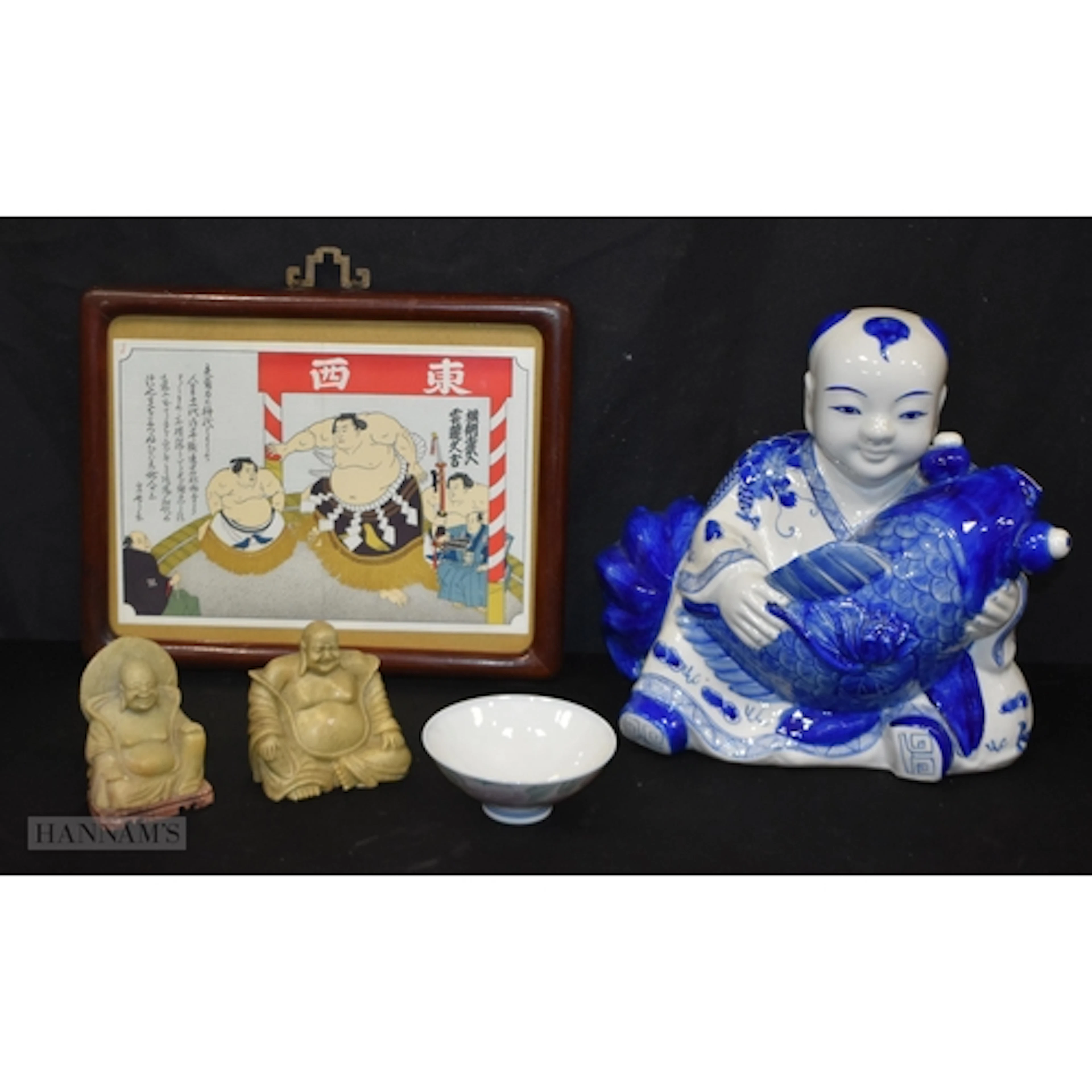 A large blue and white porcelain Buddha together with two so...