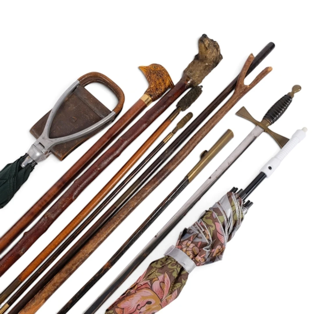 A shooting stick, gun cleaning rods, and 2 animal head-handl...