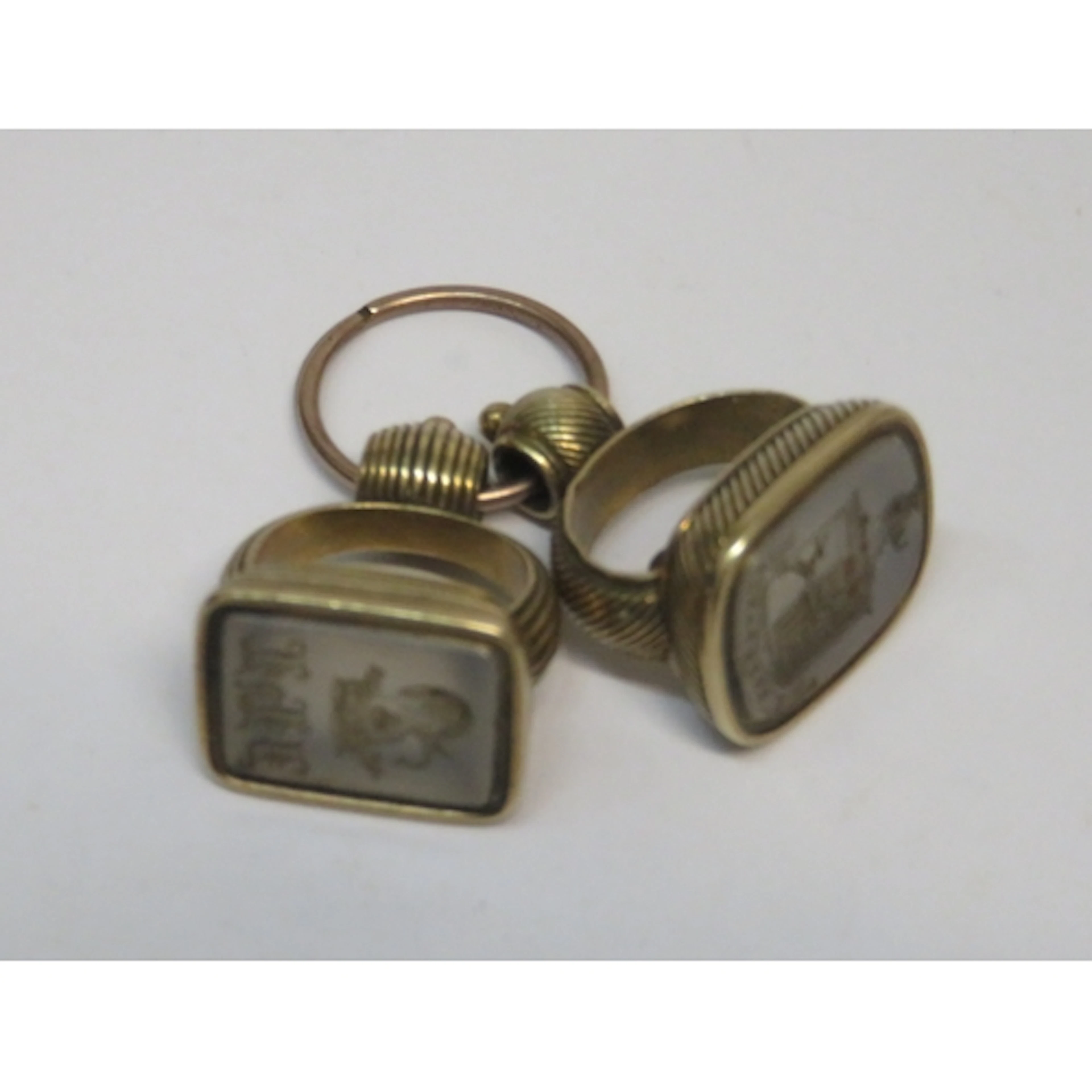 Two 19th Century yellow metal fob seals, attached to a yello...
