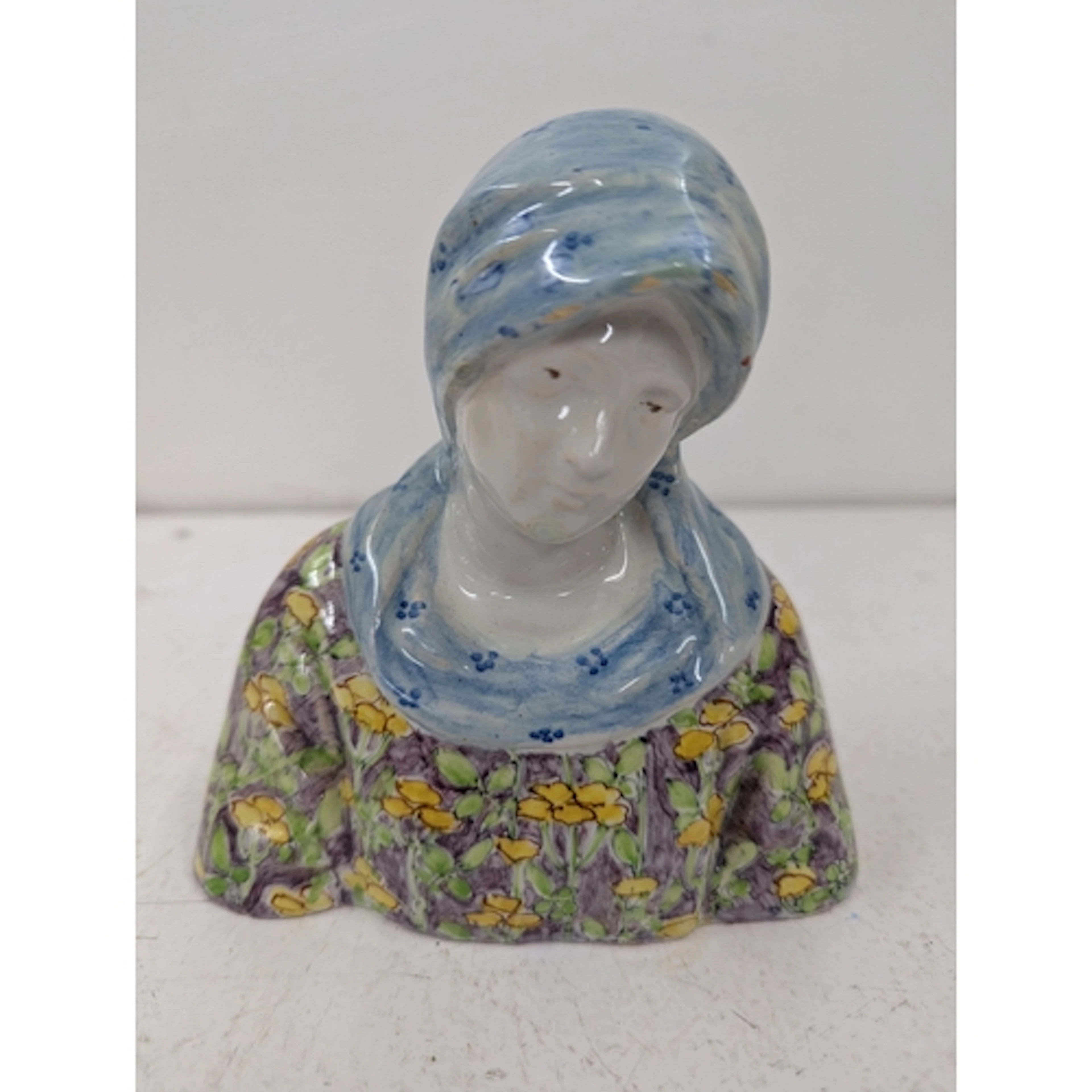 An Angelo Minghetti bust of Madonna in a floral top and a bl...