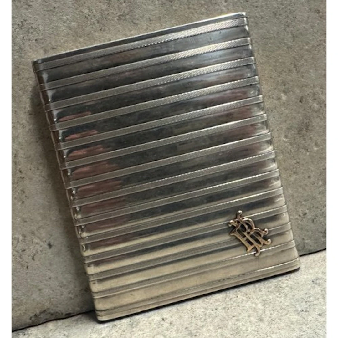 An early 20th Century silver and gold cigarette case. Approx...