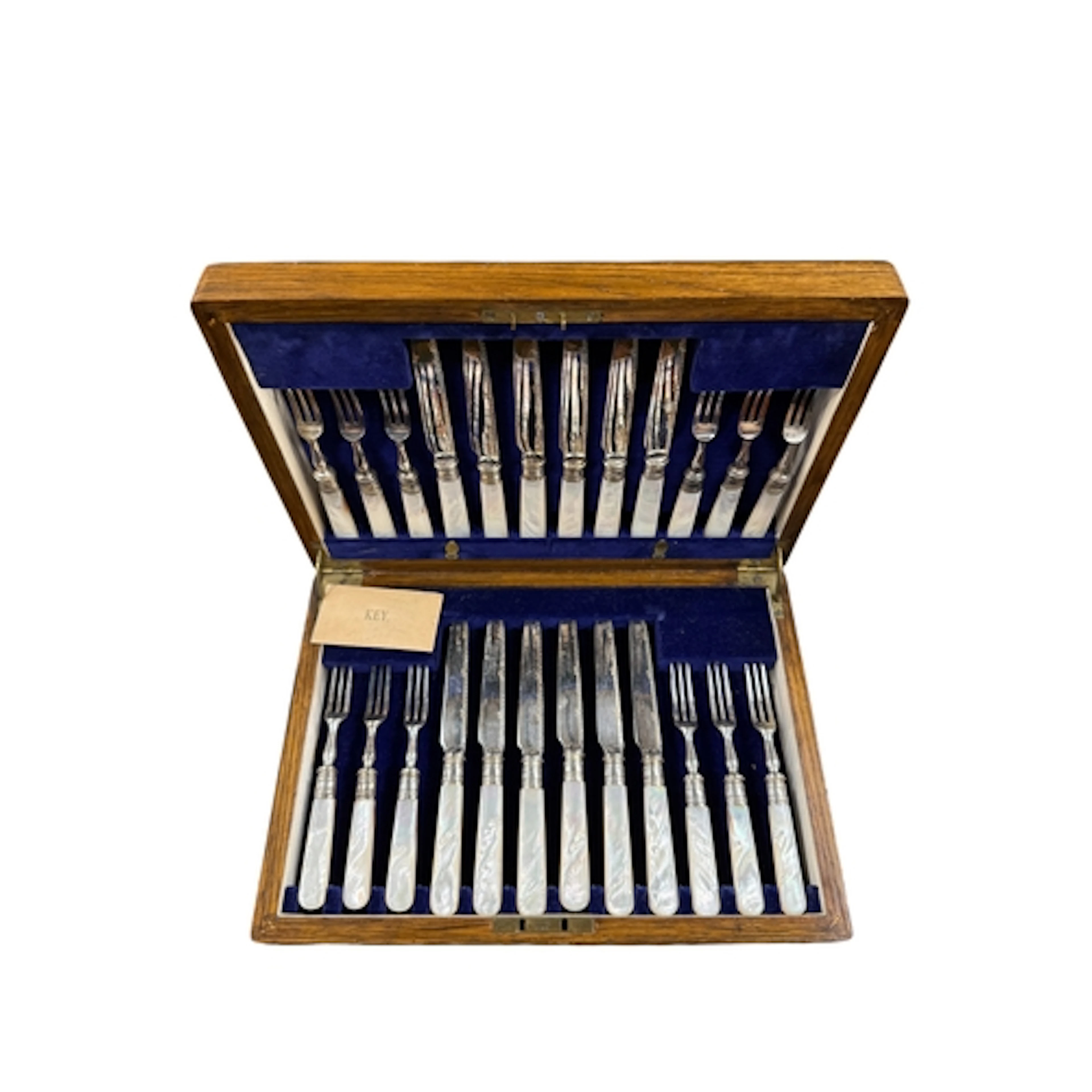 AN OAK CASED SET OF 12 PAIRS OF MOTHER OF PEARL HANDLED ELEC...