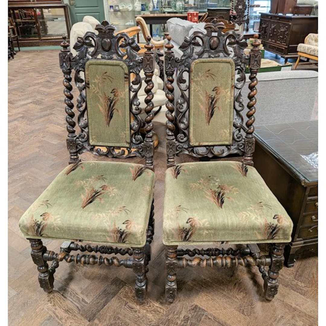 A pair of carved oak barley twist framed chairs with green p...