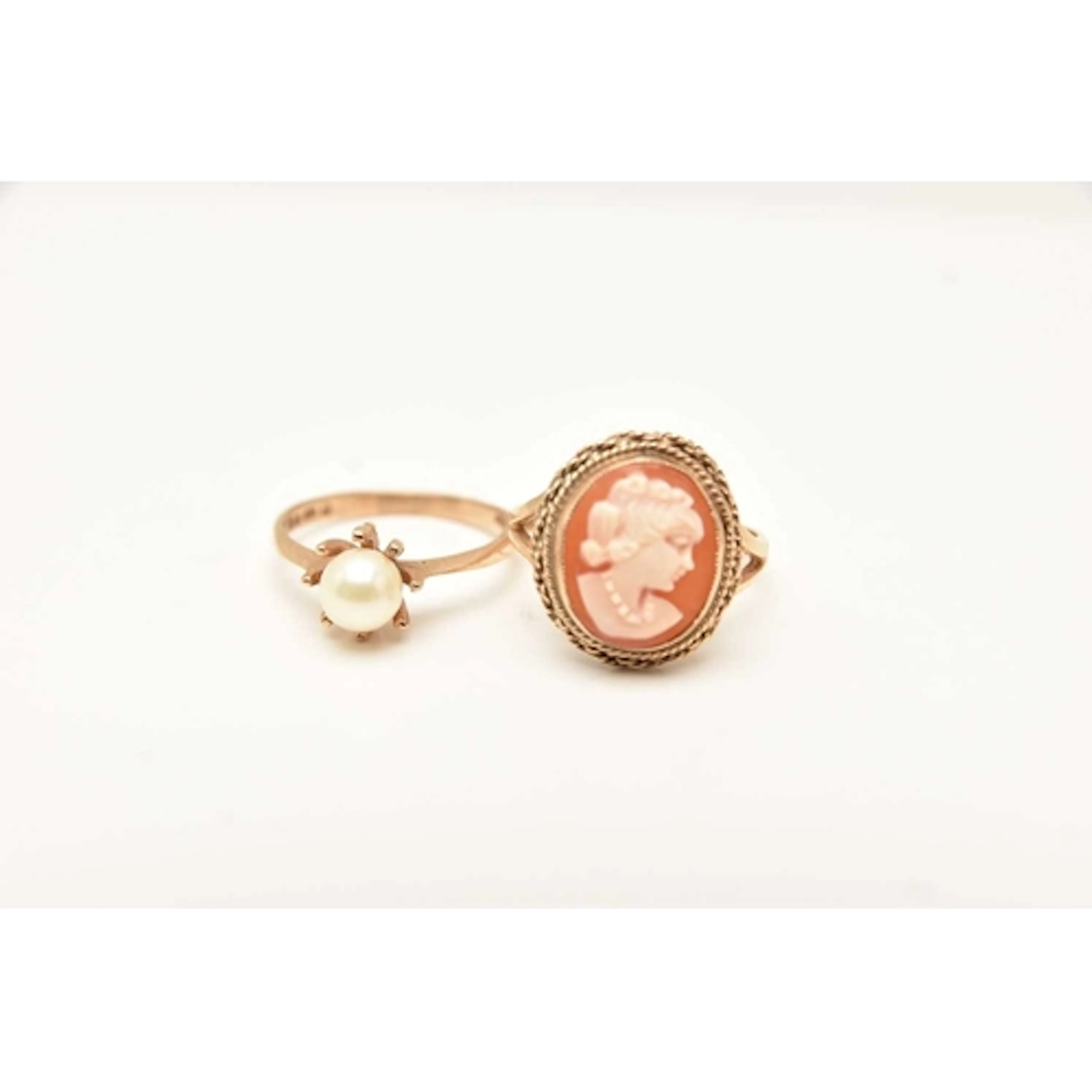 TWO 9CT GOLD RINGS, the first a cameo ring collet set within...