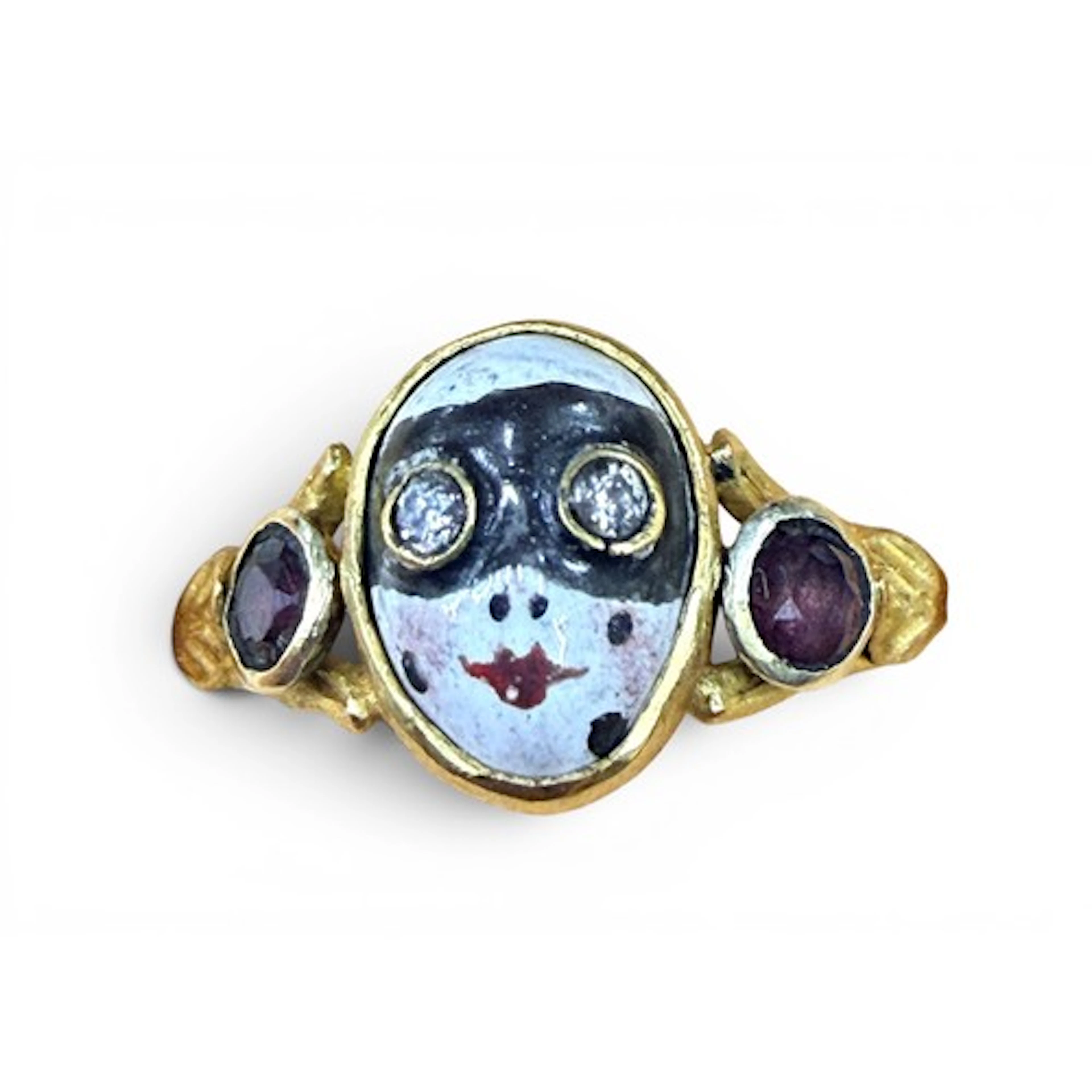 A gem-set gold and enamel masquerade ring, the central mask ...