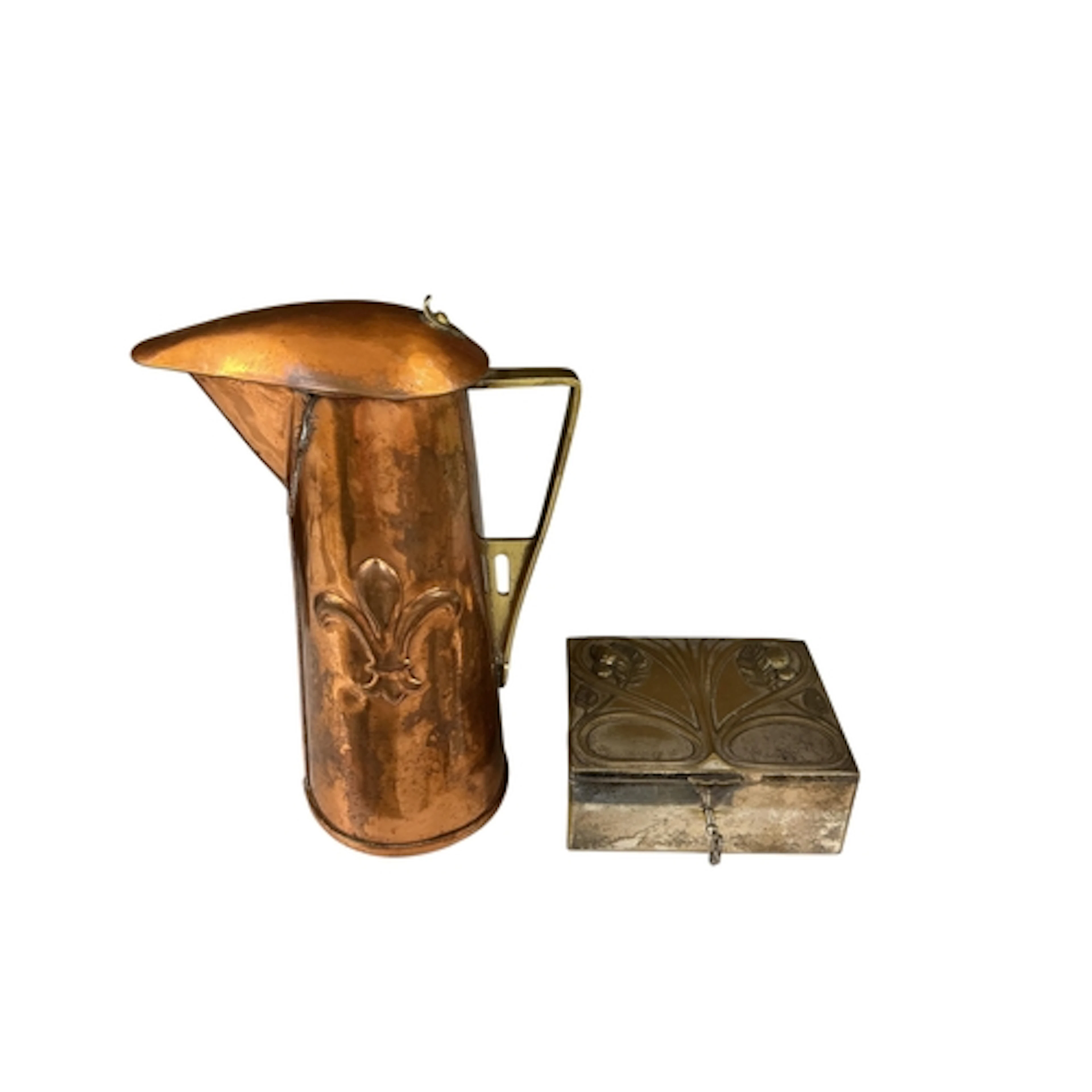 An arts and crafts style copper and brass jug embossed with ...