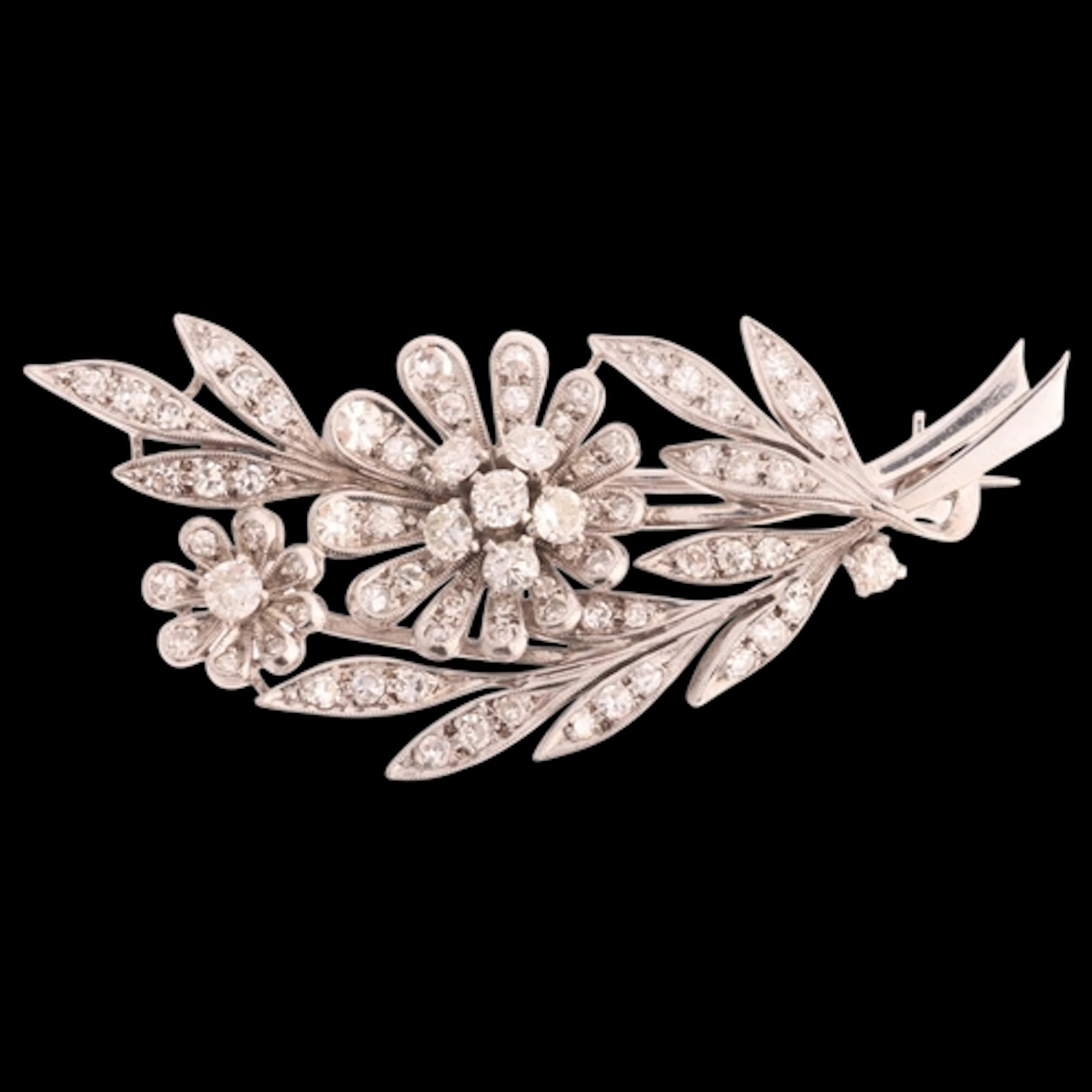 An 18ct white gold diamond floral spray brooch, circa 1950, ...