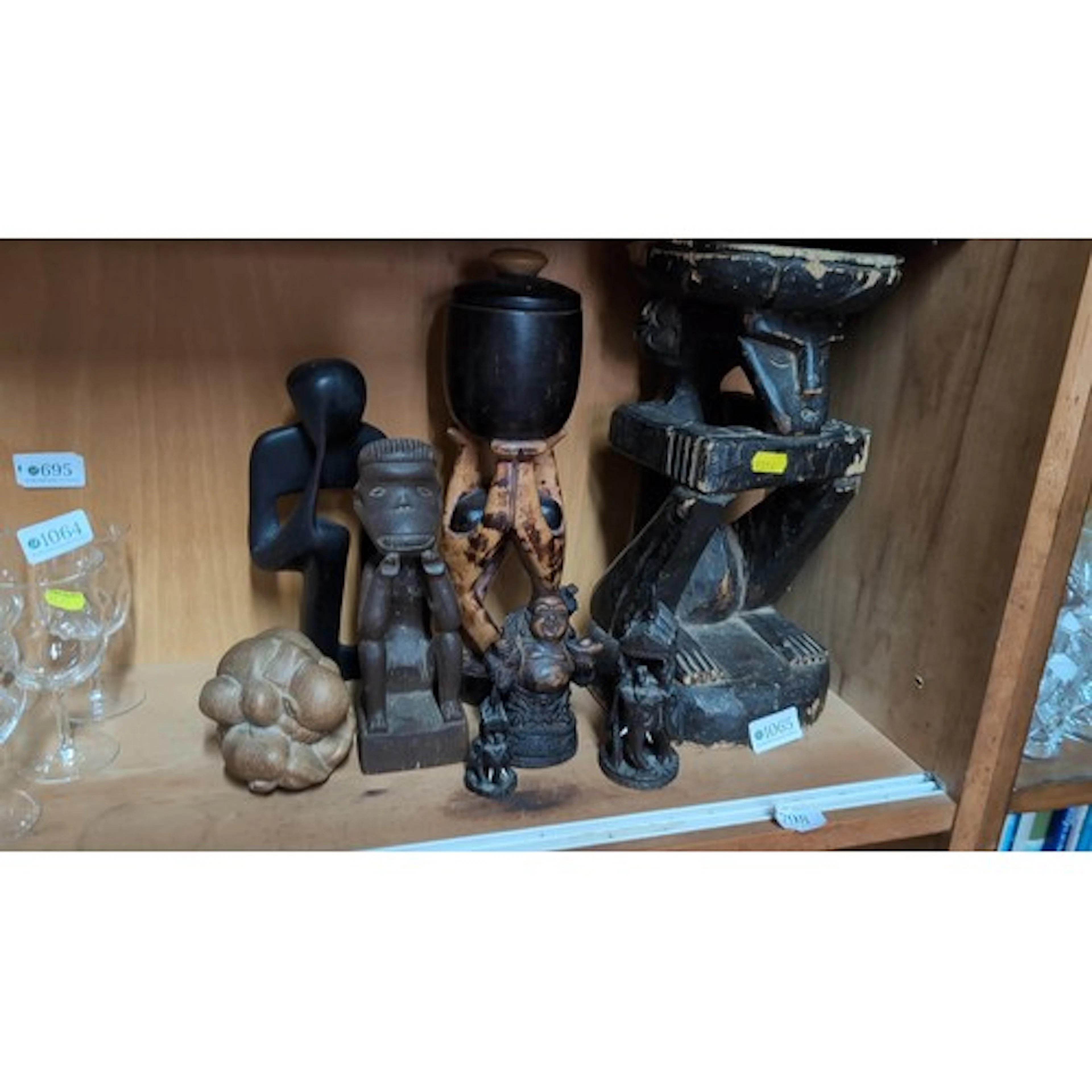 A collection of carved figural sculptures, predominantly in ...