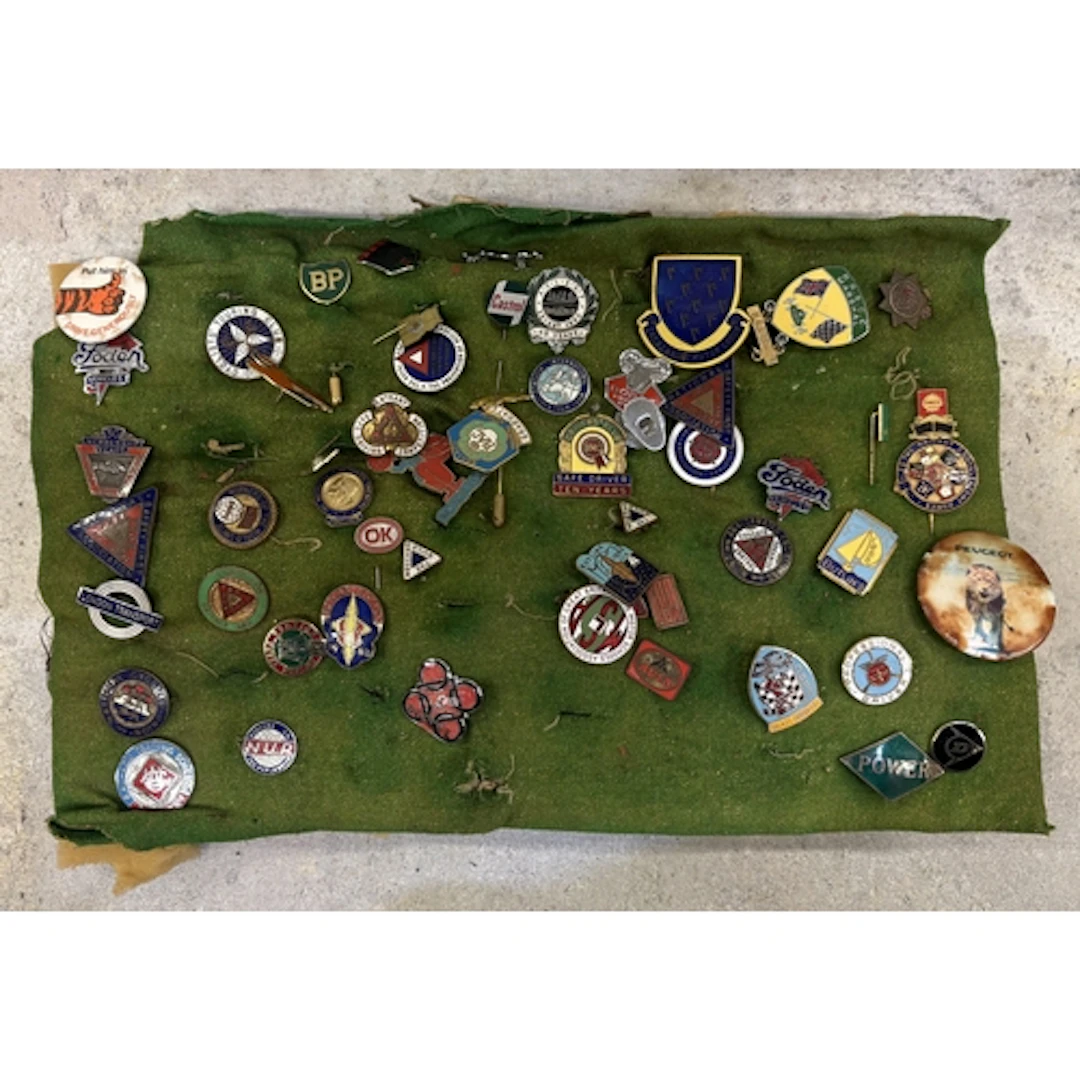 A collection of enamel motoring and other pin badges. Est. £...