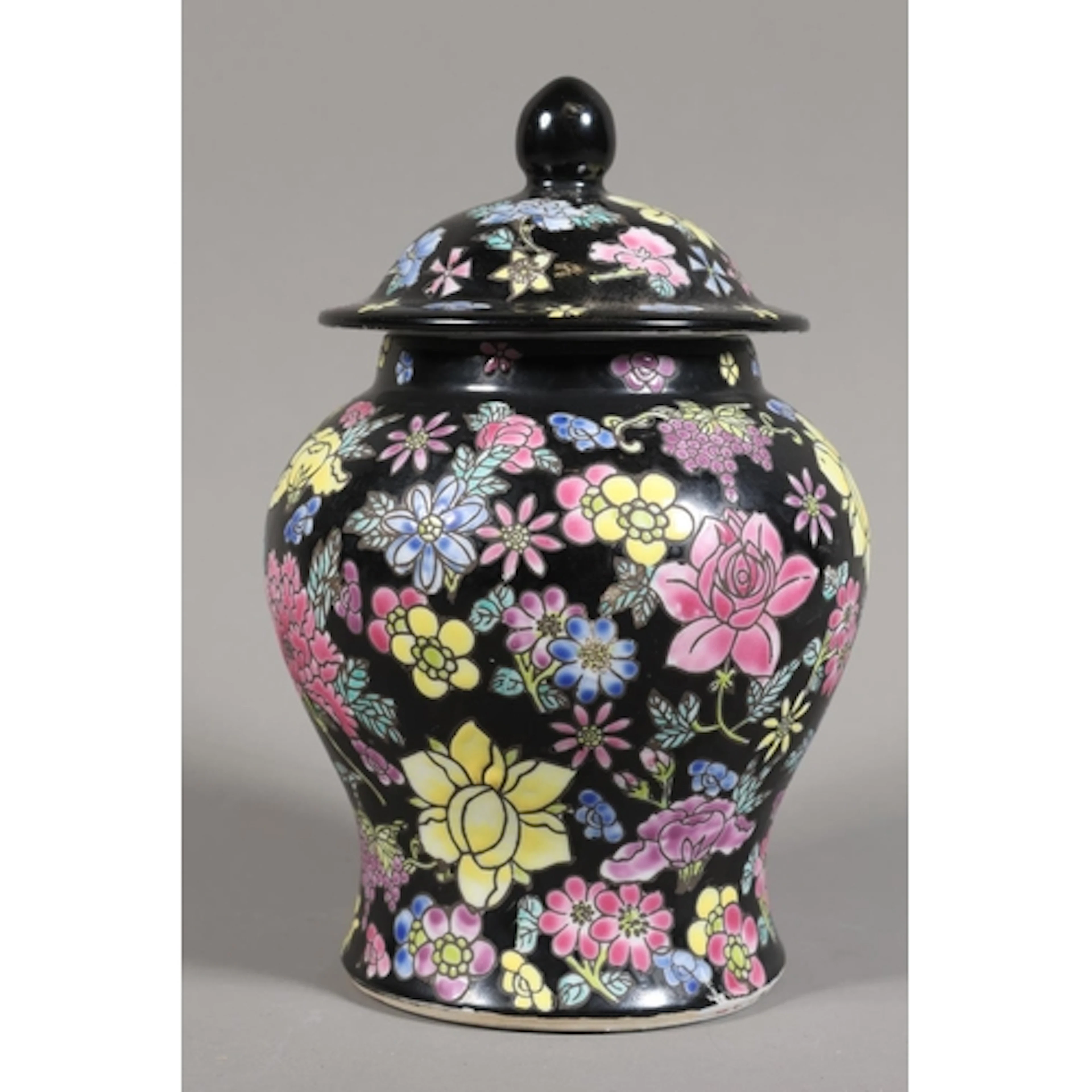 Chinese vase and cover with black ground and all-over foliat...