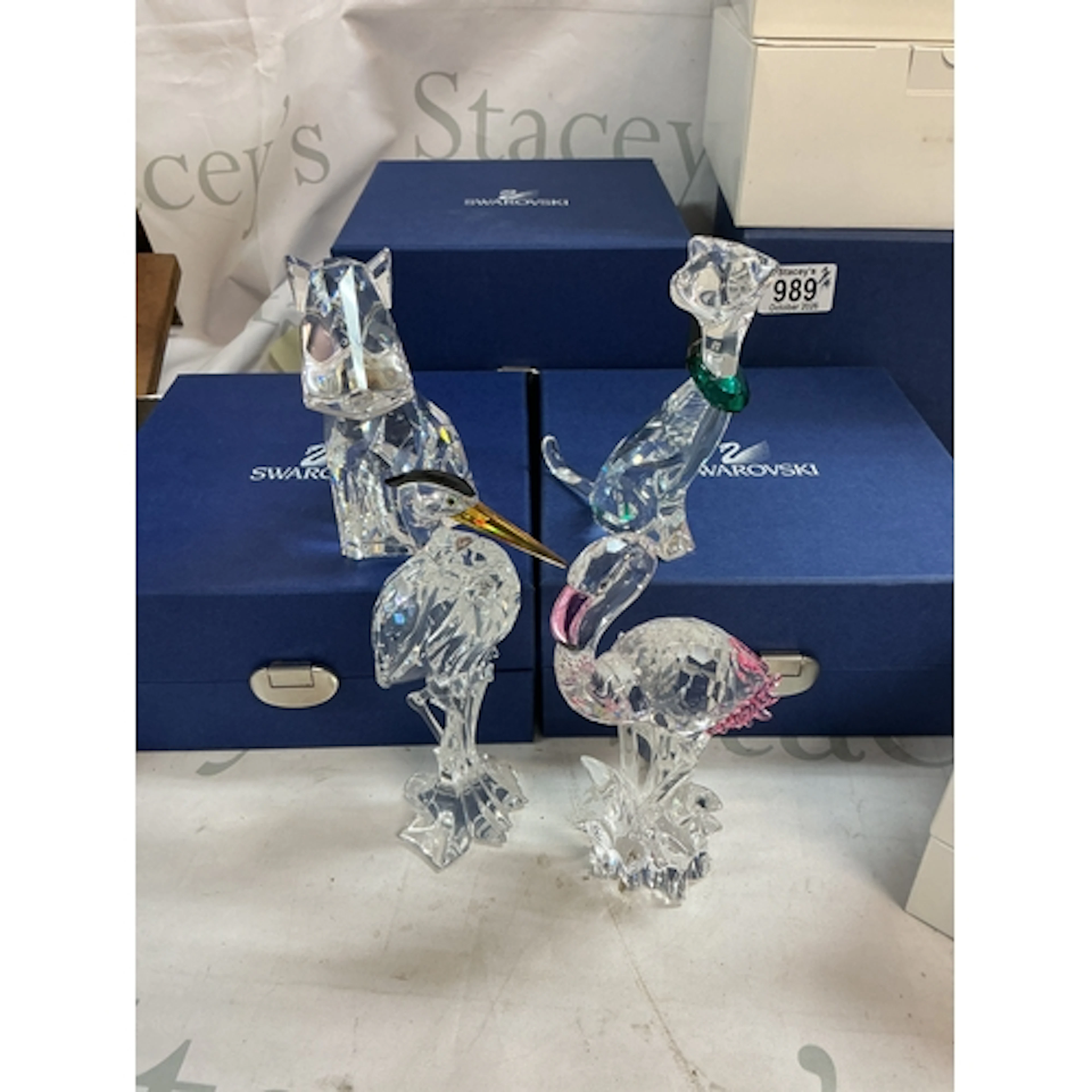 A collection of 4 Swarovski animal figures including dogs an...