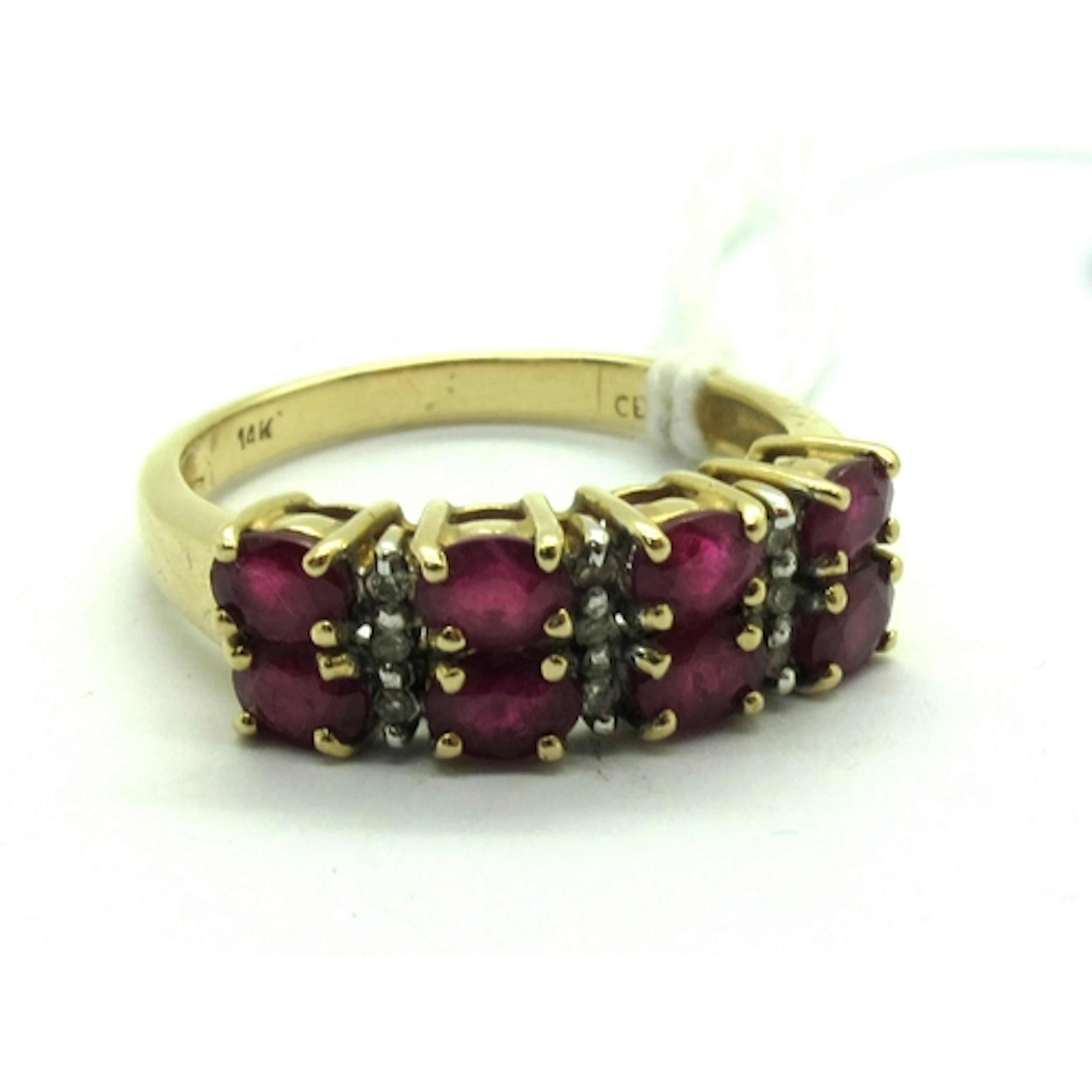 A Modern Ruby and Diamond Dress Ring, oval claw set with alt...