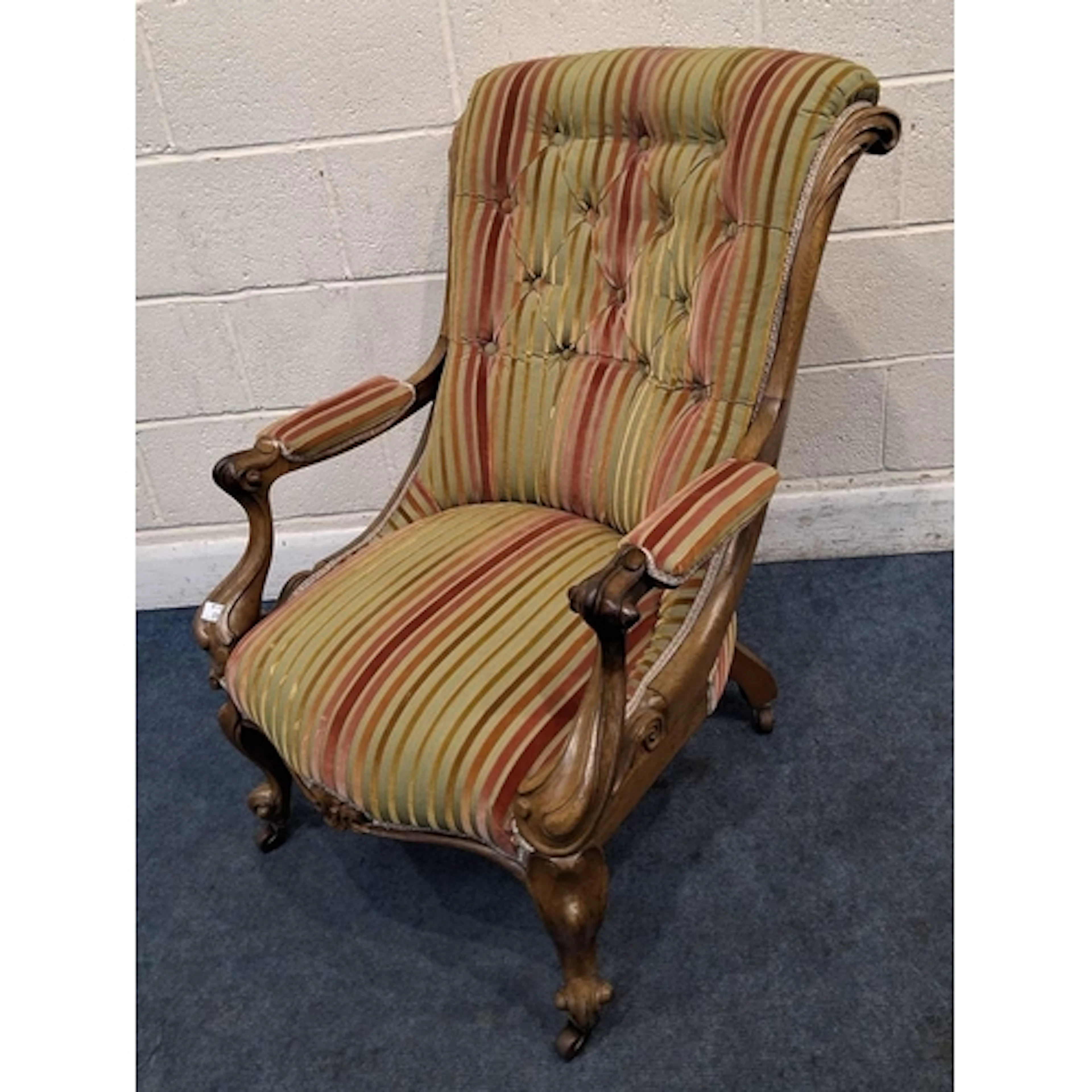 A 19TH CENTURY WALNUT EASY CHAIR, with striped upholstery, s...