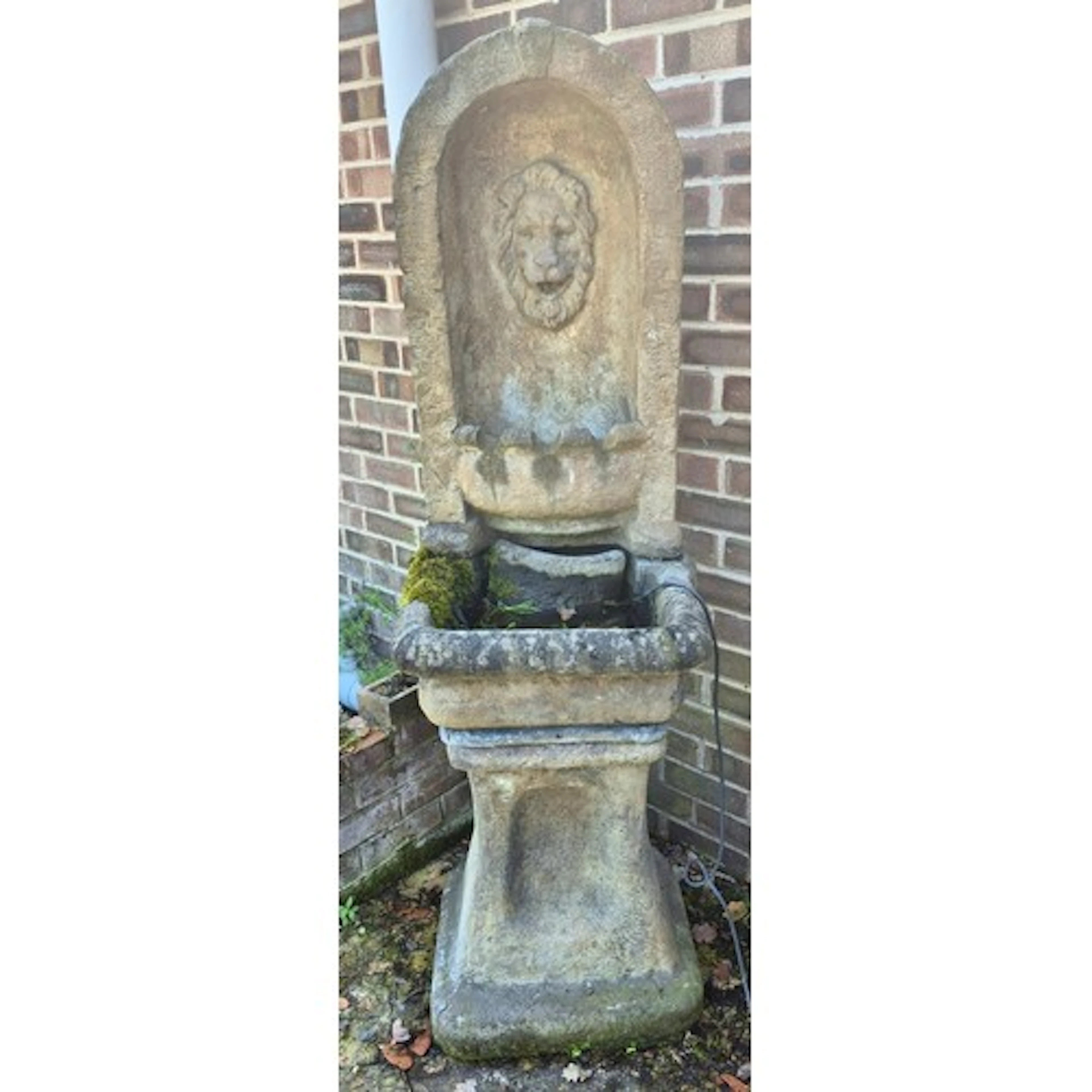 Stone fountain with lion mask to back. 170cm h x 50cm w x 60...
