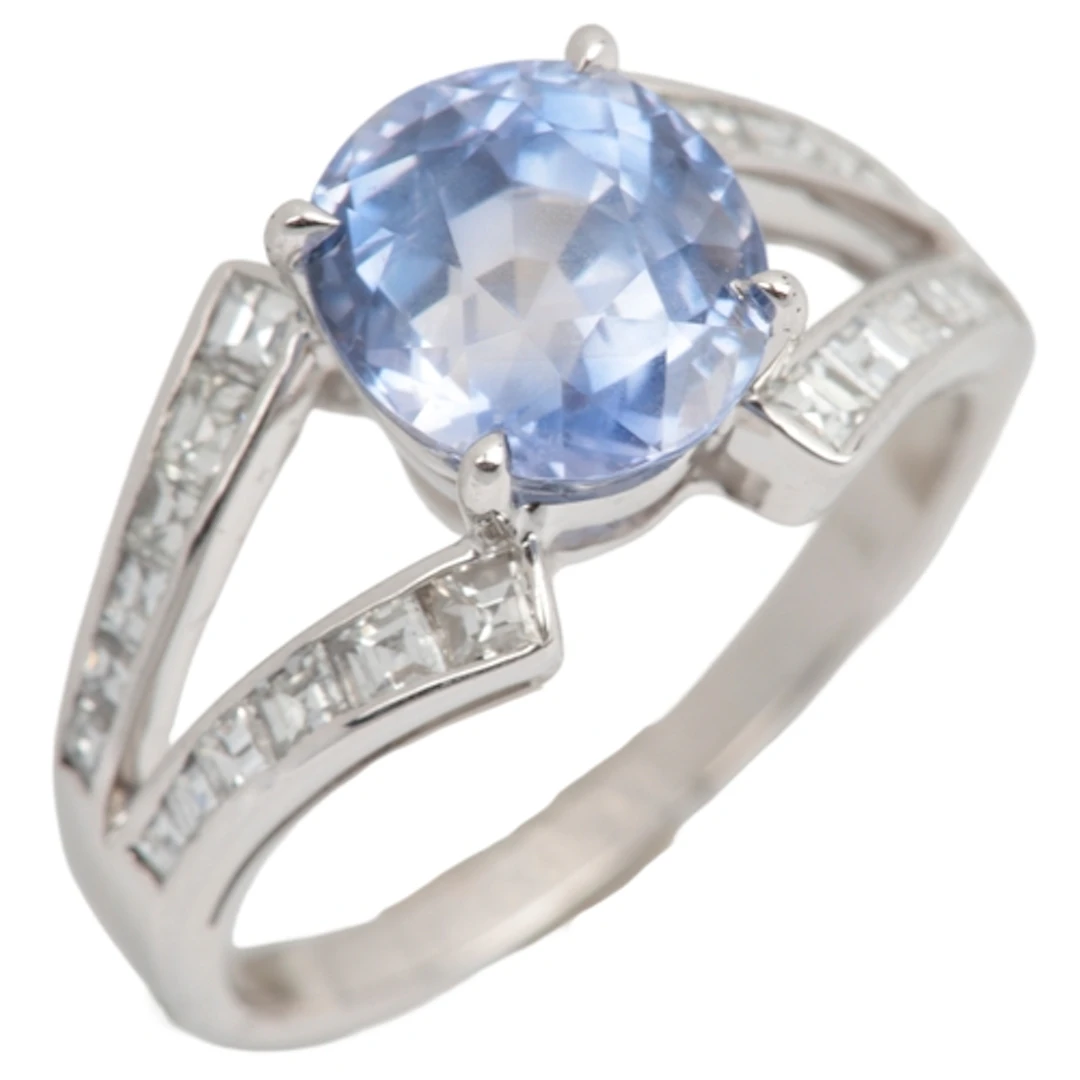 A sapphire and diamond ring, claw-set with an oval cuchion-s...