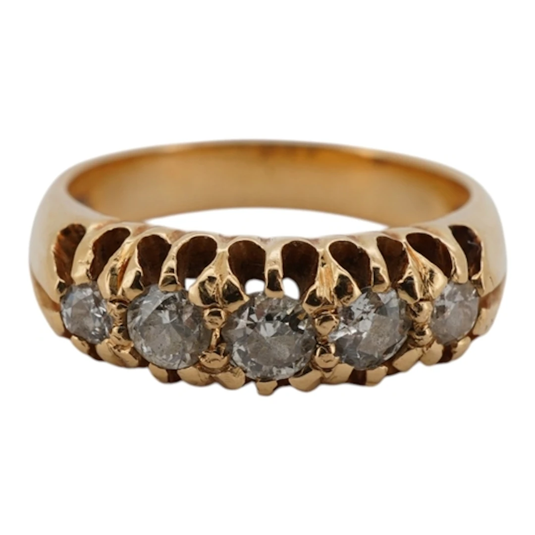 A yellow metal and graduated claw set five stone diamond set...