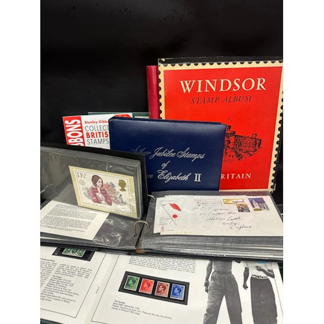 A collection of first day cover stamps in three albums, stam...