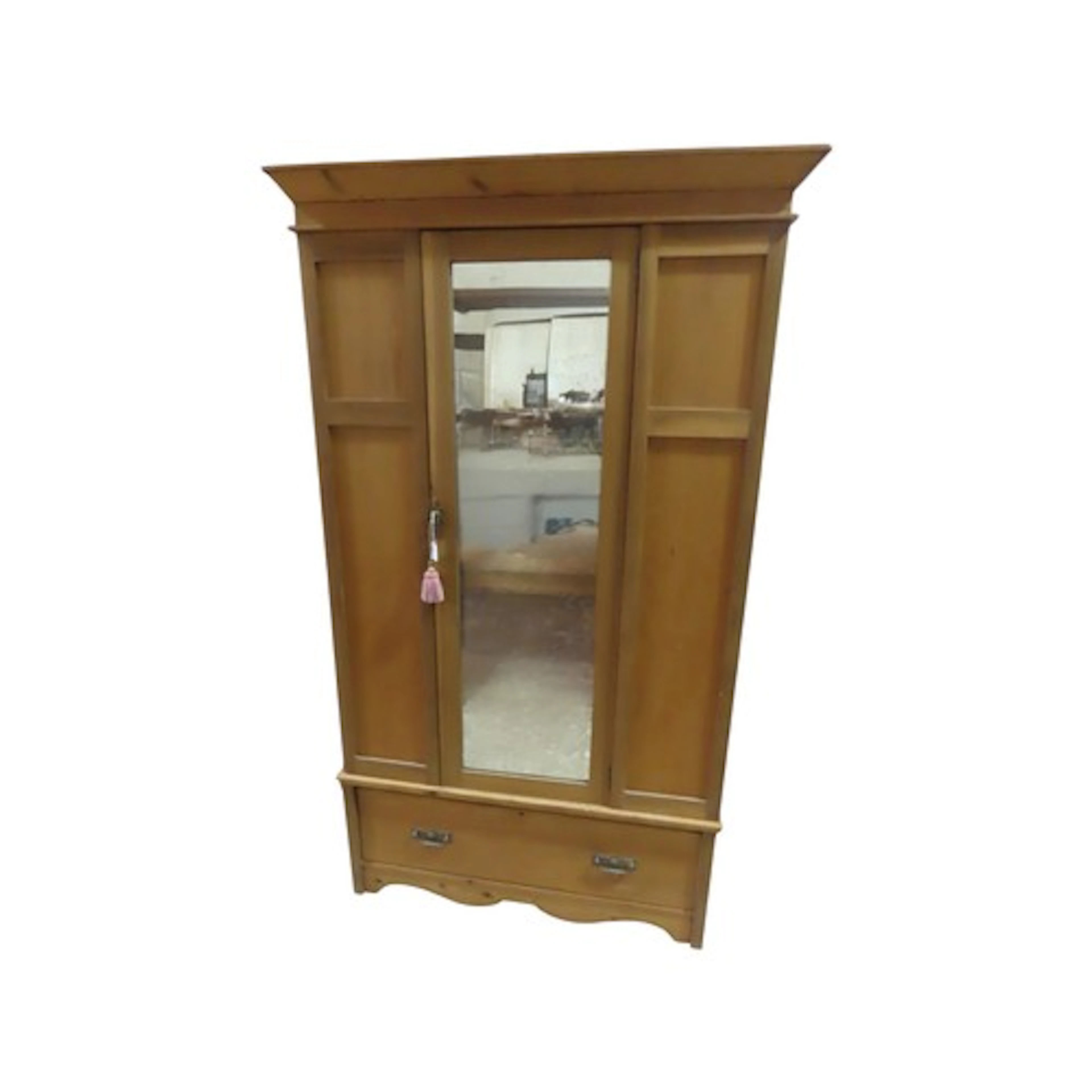 A stripped pine wardrobe enclosed by a central three quarter...