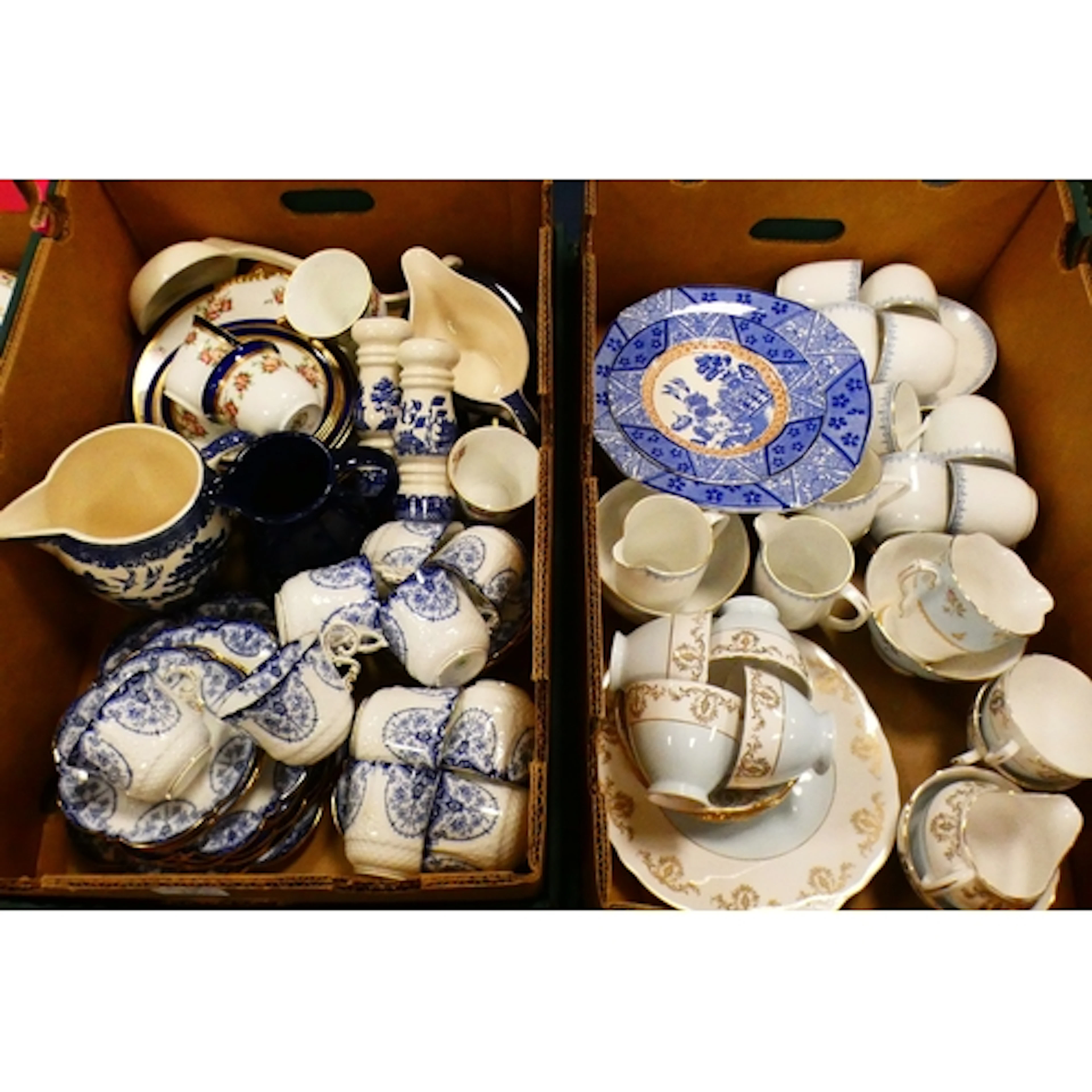 Two boxes of assorted china tea wares to include a part blue...