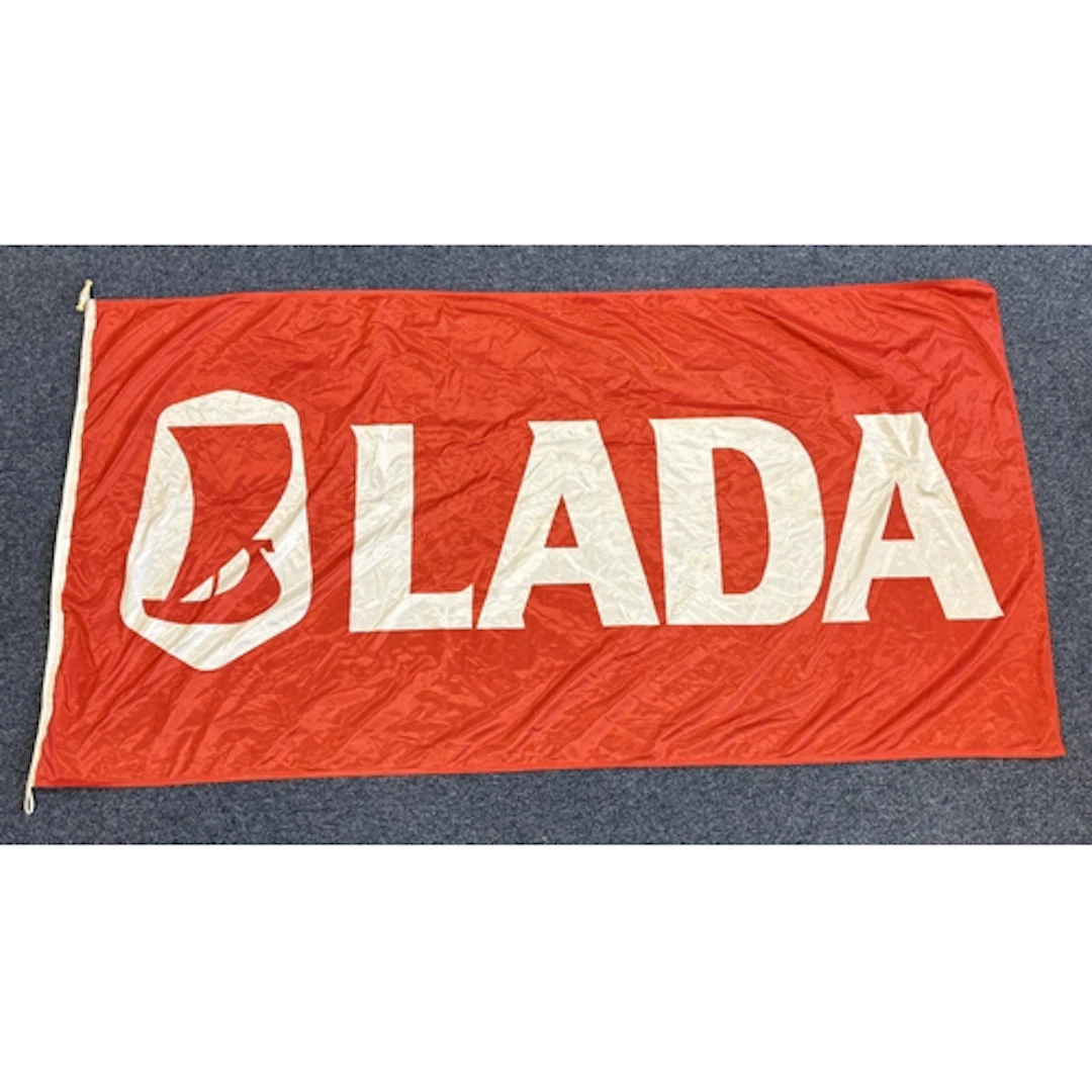 A large red and white "Lada" flag. Est. £20 - £30.