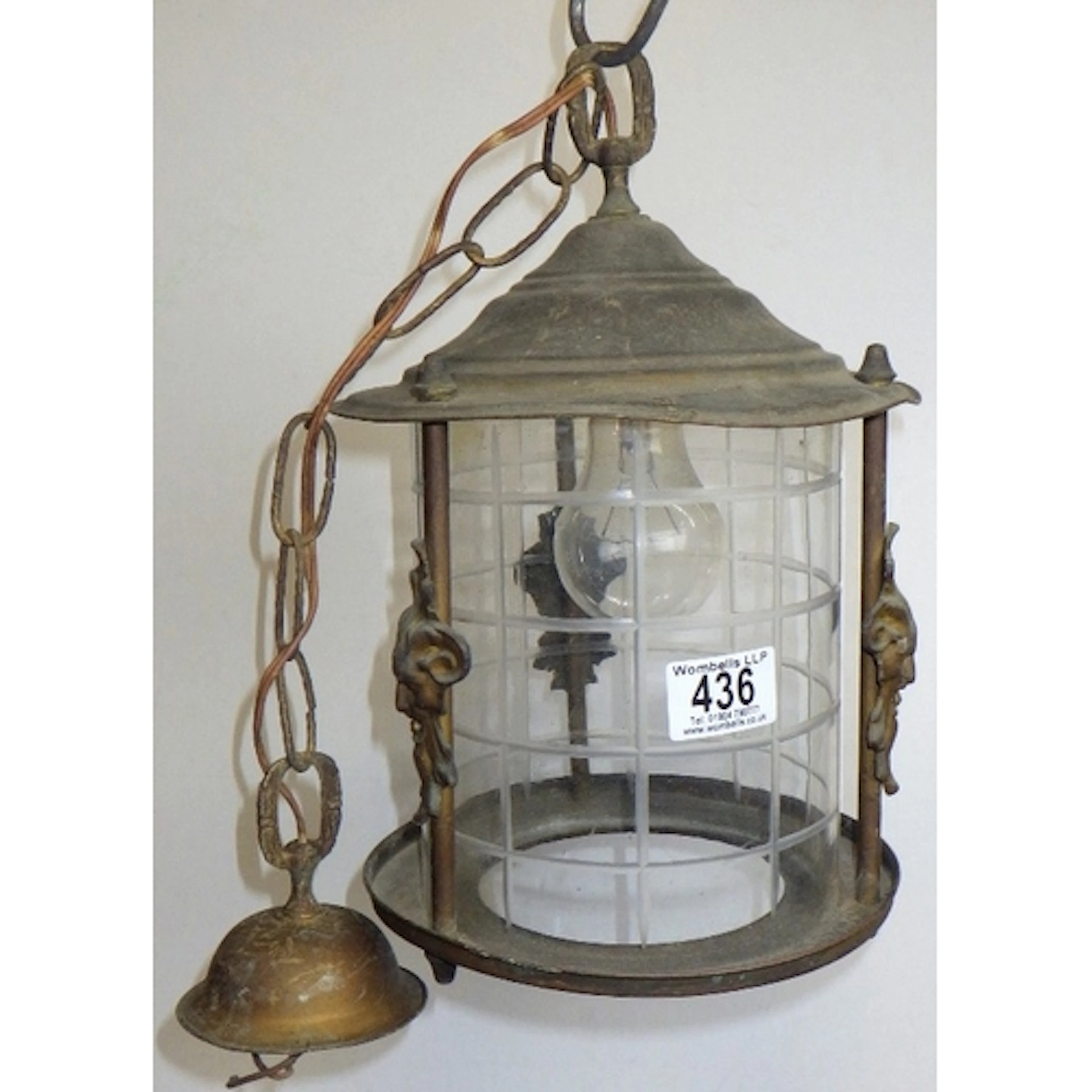 A hanging lantern with mask decorations, 30cm tall