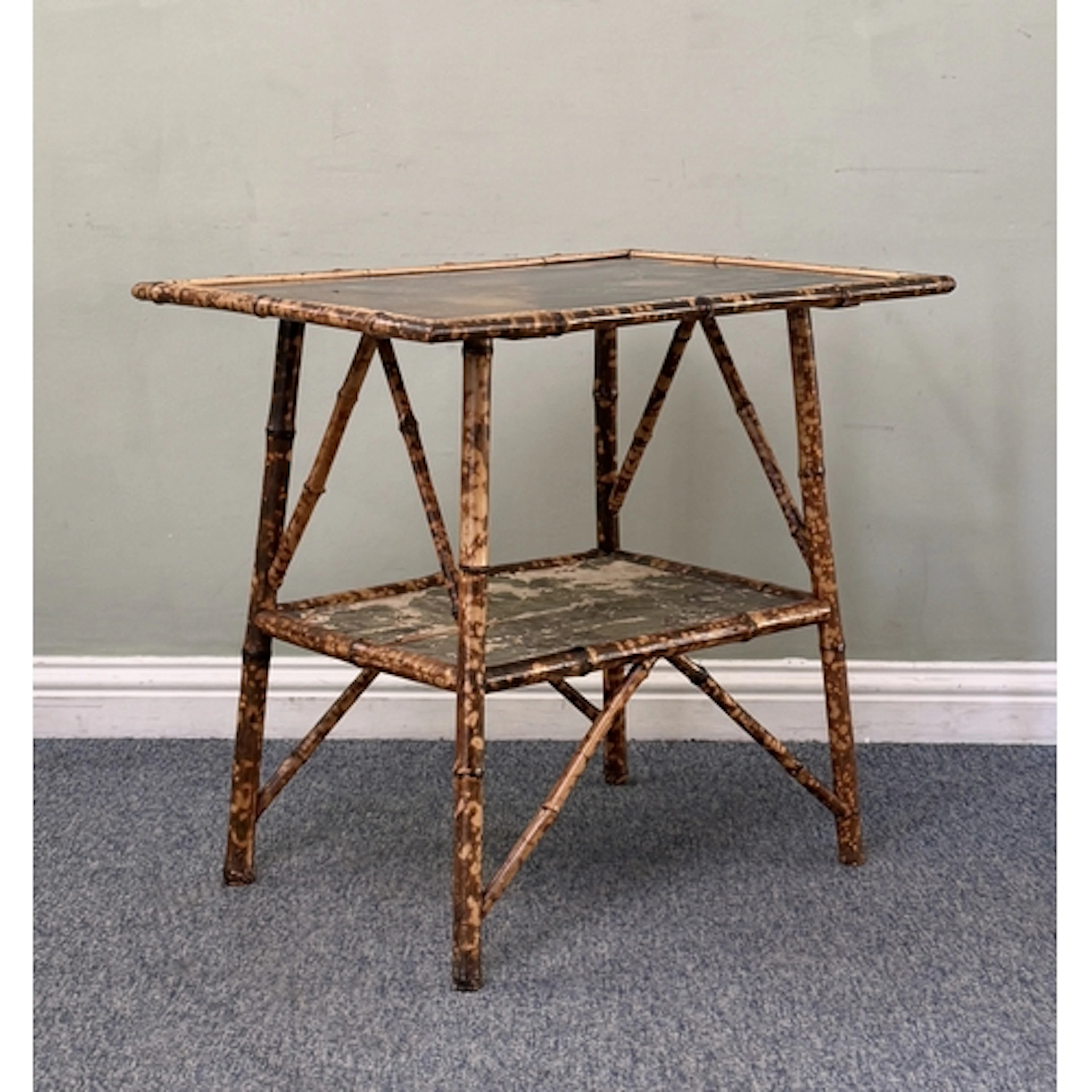 A Victorian bamboo and lacquered centre table in the Aesthet...